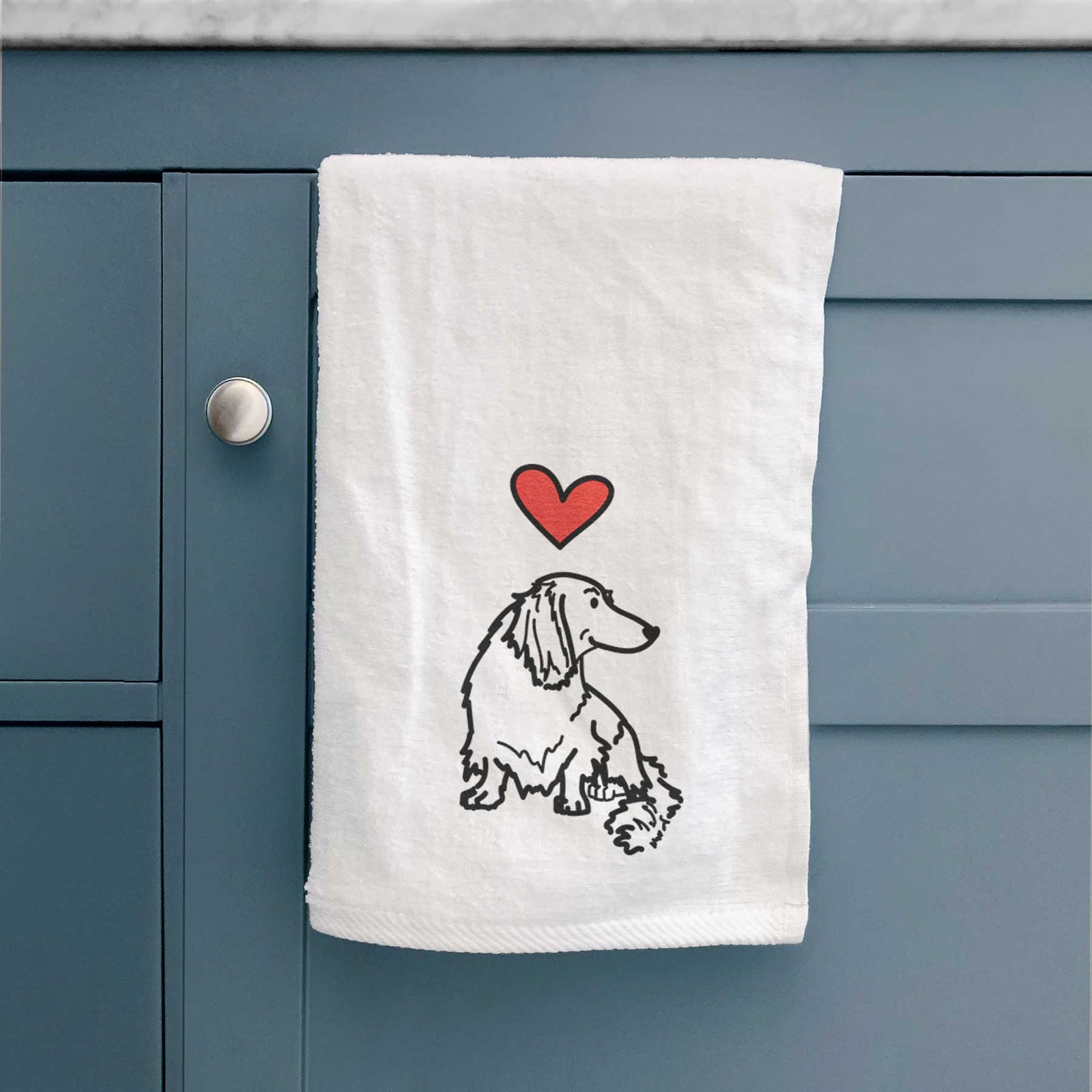 Minimalist line drawing of Bella the Dachshund with a red heart on a decorative hand towel