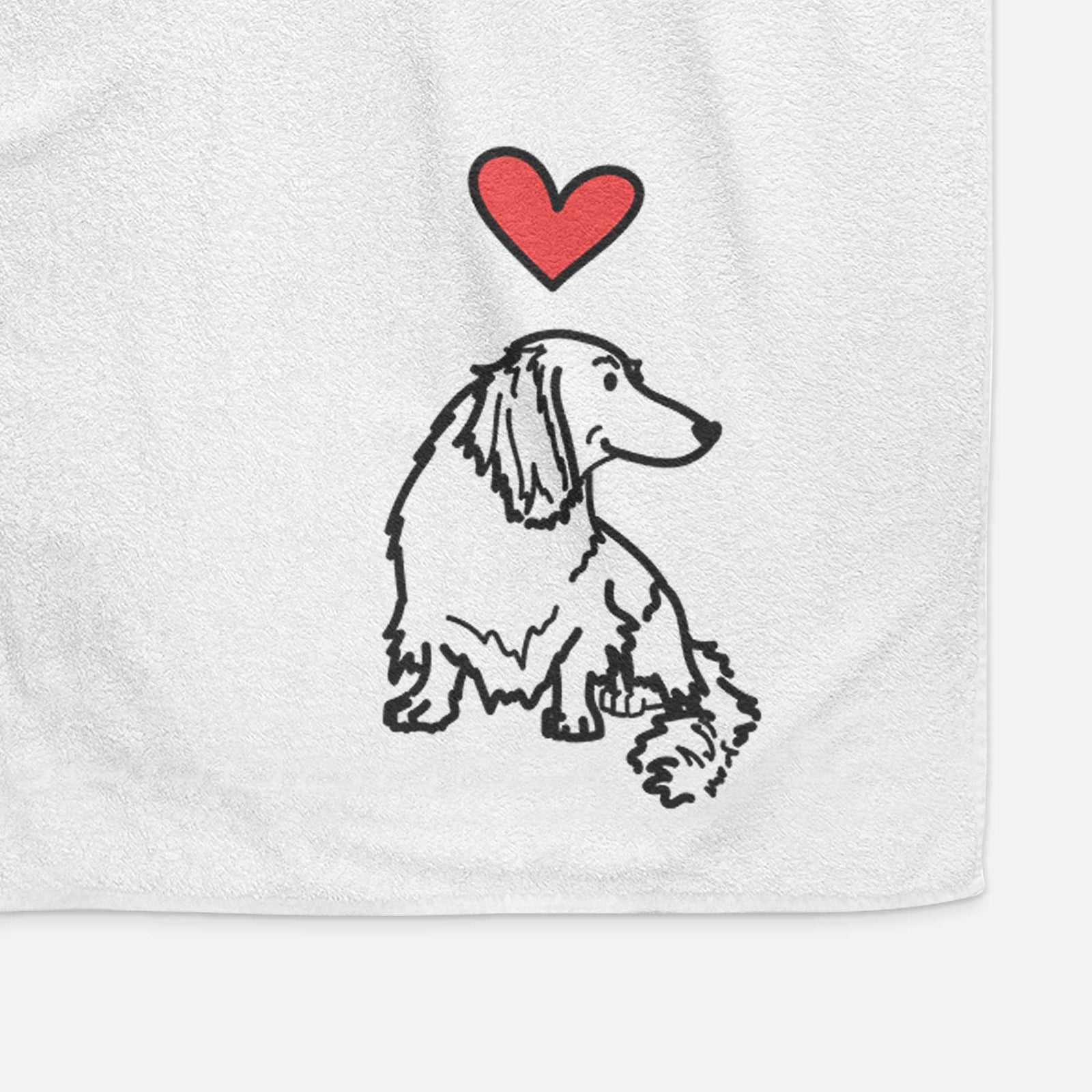 Minimalist line drawing of Bella the Dachshund with a red heart on a decorative hand towel