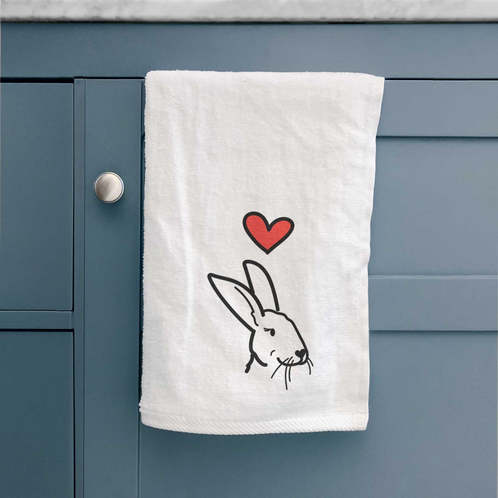 Minimalist line drawing of Betsy the Rex Rabbit with a red heart on a decorative hand towel