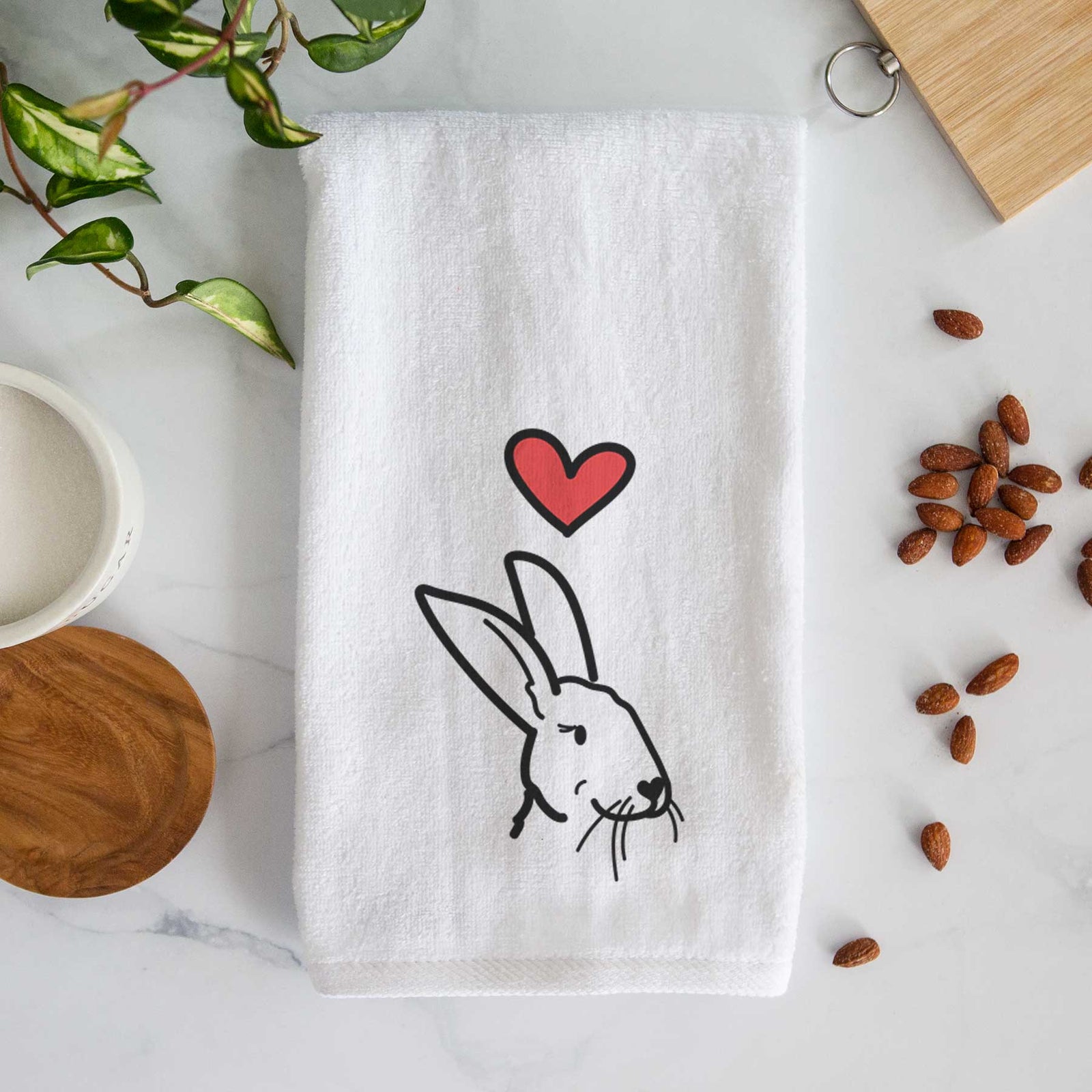 Minimalist line drawing of Betsy the Rex Rabbit with a red heart on a decorative hand towel