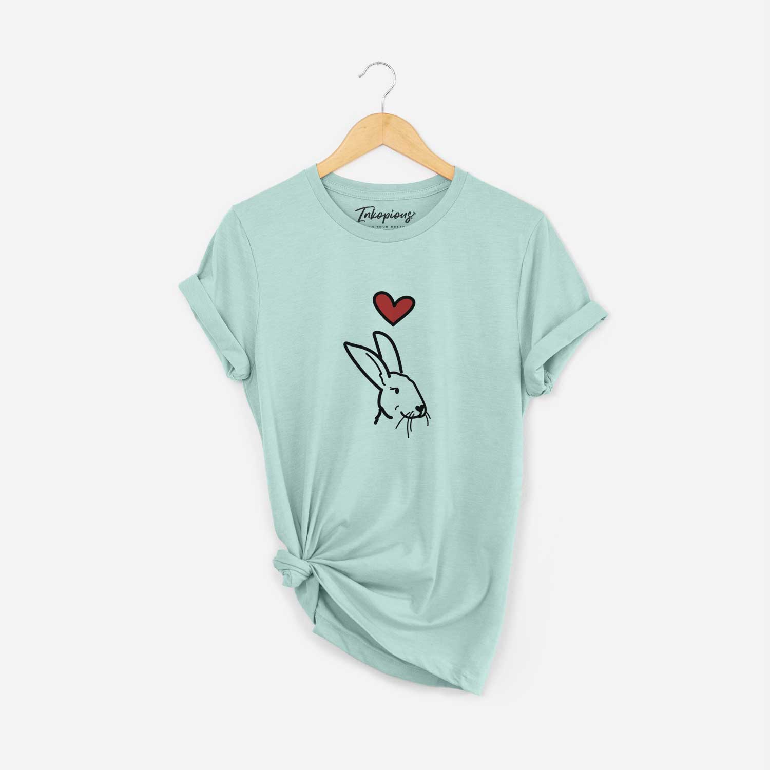 Minimalist line drawing of Betsy the Rex Rabbit with a red heart on a Heather Sage Unisex crewneck