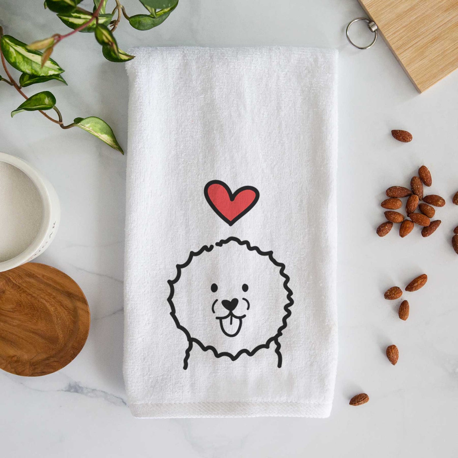 Minimalist line drawing of a Bichon Frise with a red heart on a decorative hand towel