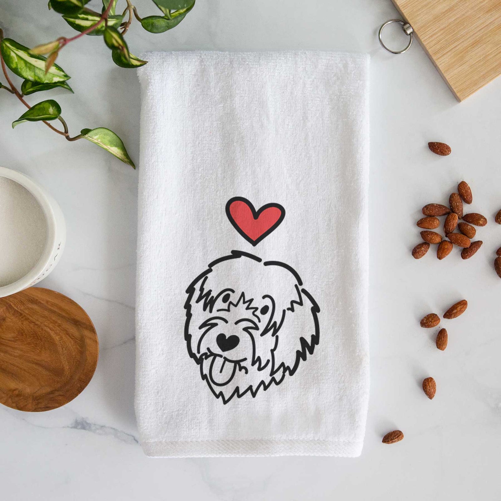 Minimalist line drawing of a Catalan Sheepdog with a red heart on a decorative hand towel