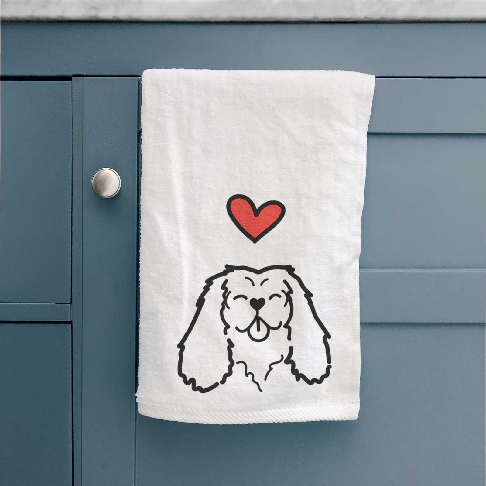 Minimalist line drawing of a Cavalier King Charles Spaniel with a red heart on a decorative hand towel