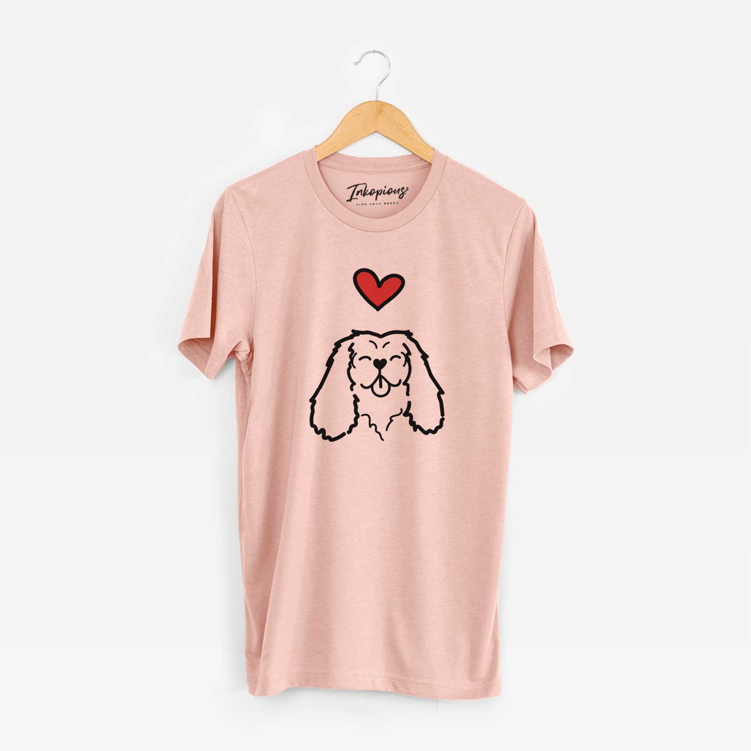 Minimalist line drawing of a Cavalier King Charles Spaniel with a red heart on a Peach Unisex crewneck