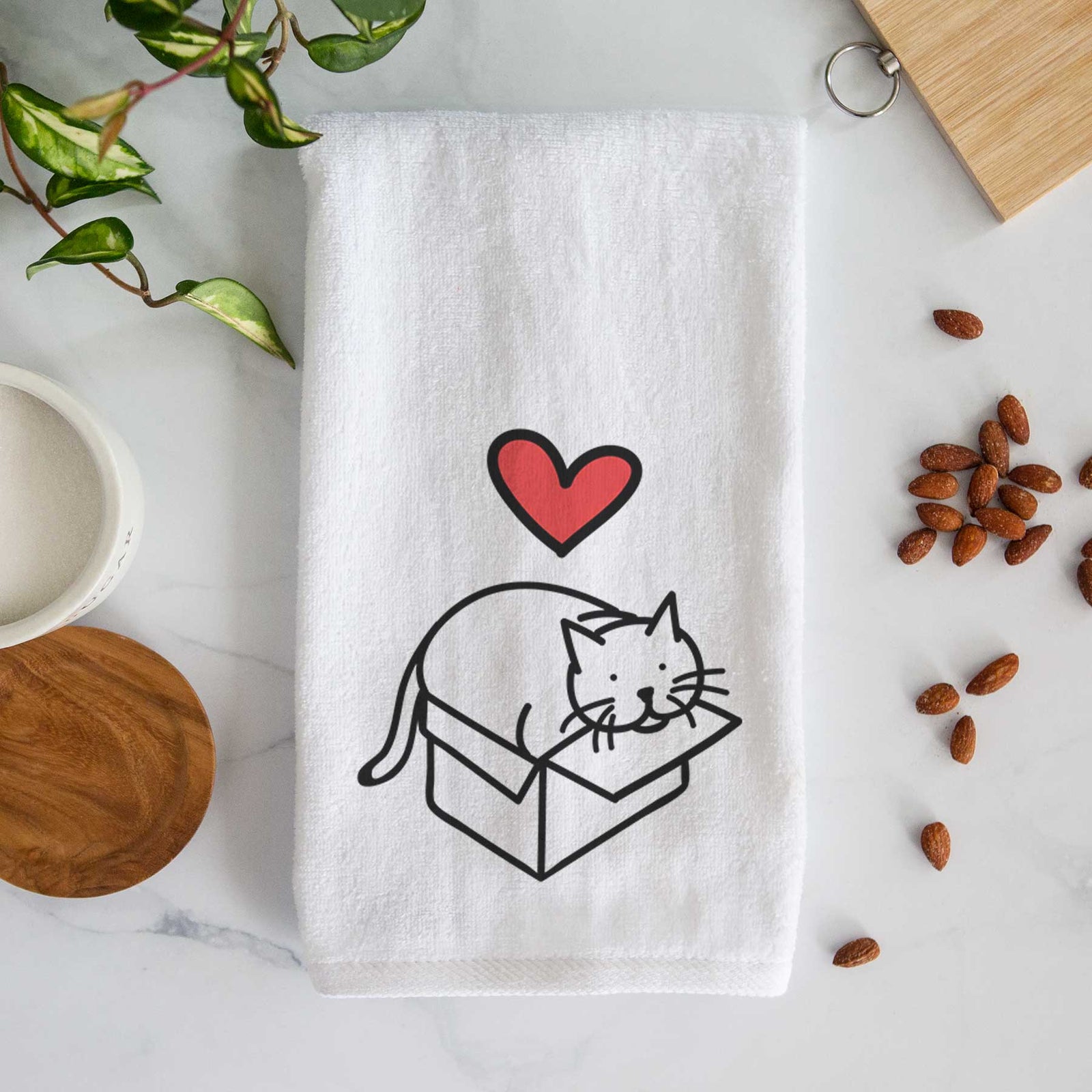 Minimalist line drawing of Charlie the Cat in a Box with a red heart on a decorative hand towel