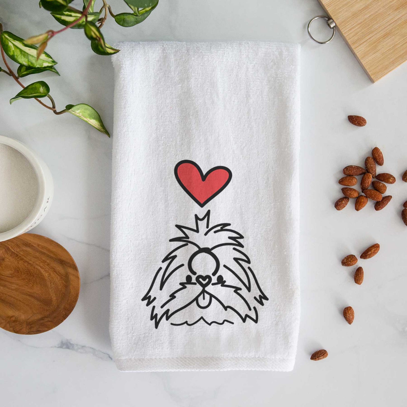 Minimalist line drawing of CoCo the Shih Tzu with a red heart on a decorative hand towel