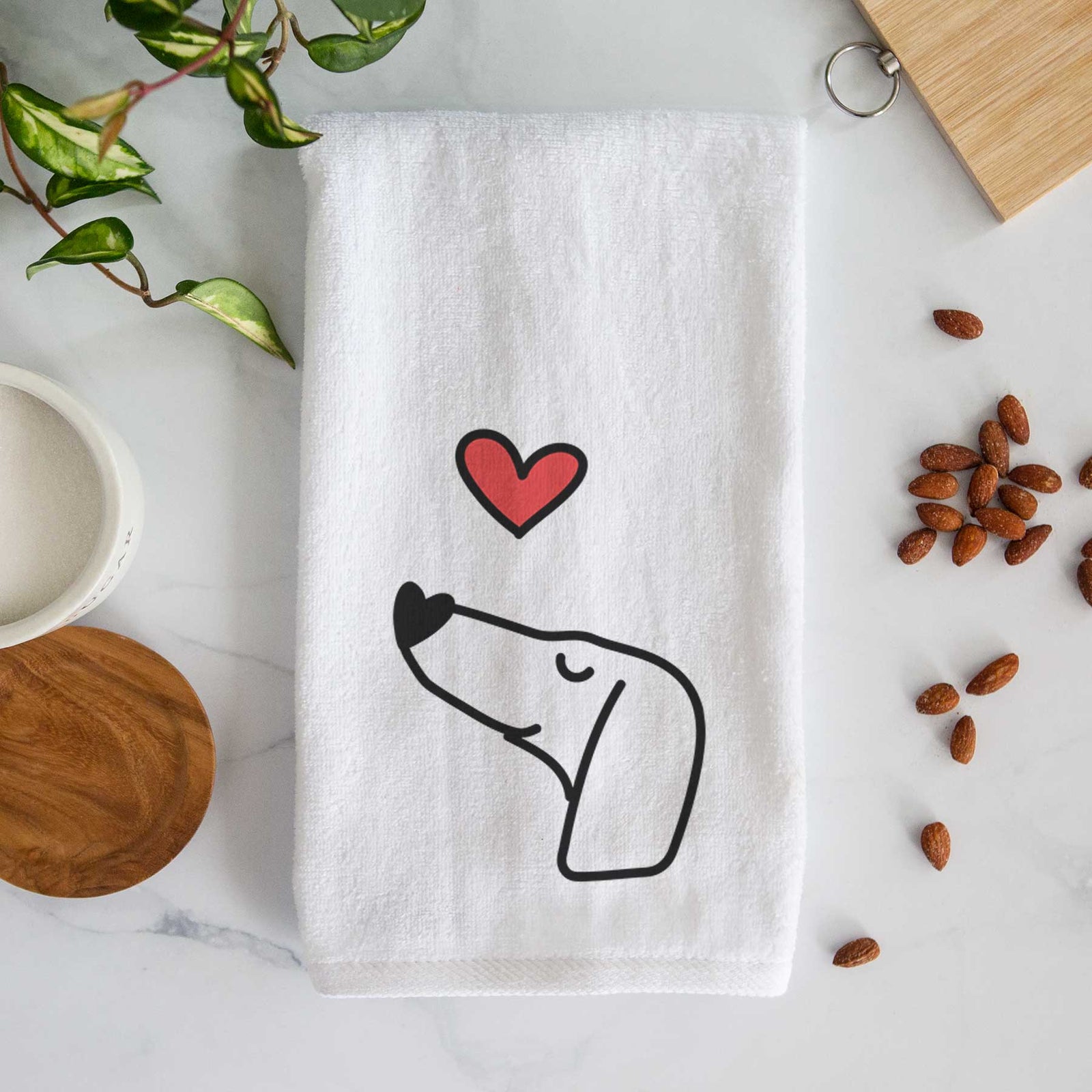 Minimalist line drawing of a Dachshund with a red heart on a decorative hand towel