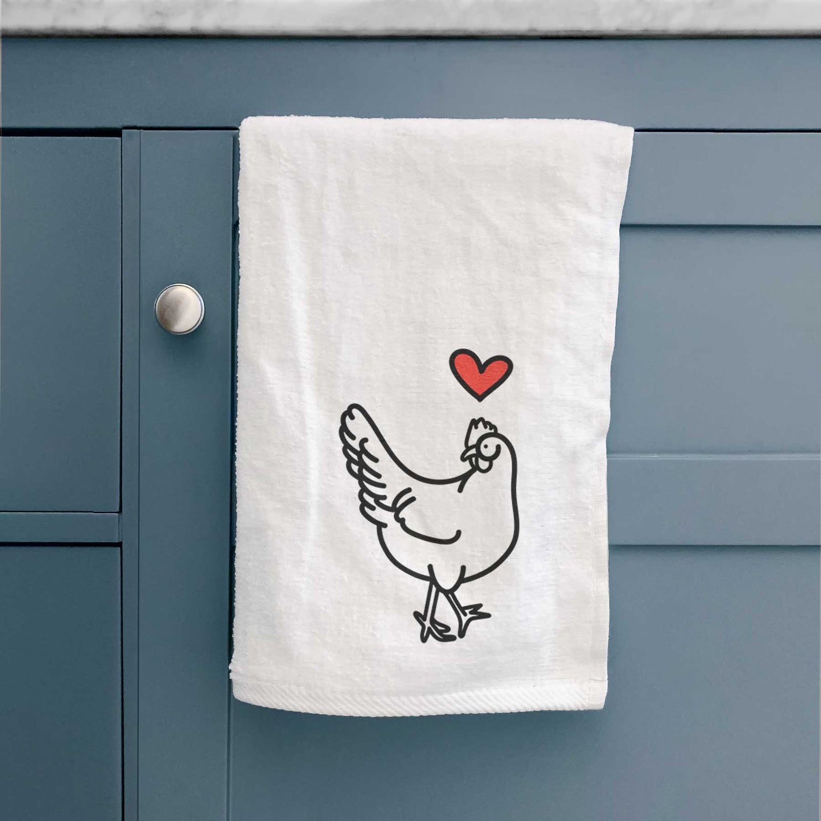 Minimalist line drawing of Daisy the Chicken with a red heart on a decorative hand towel