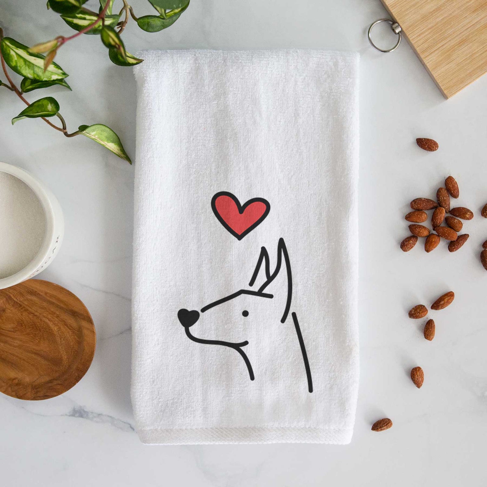 Minimalist line drawing of a Doberman Pinscher with a red heart on a decorative hand towel