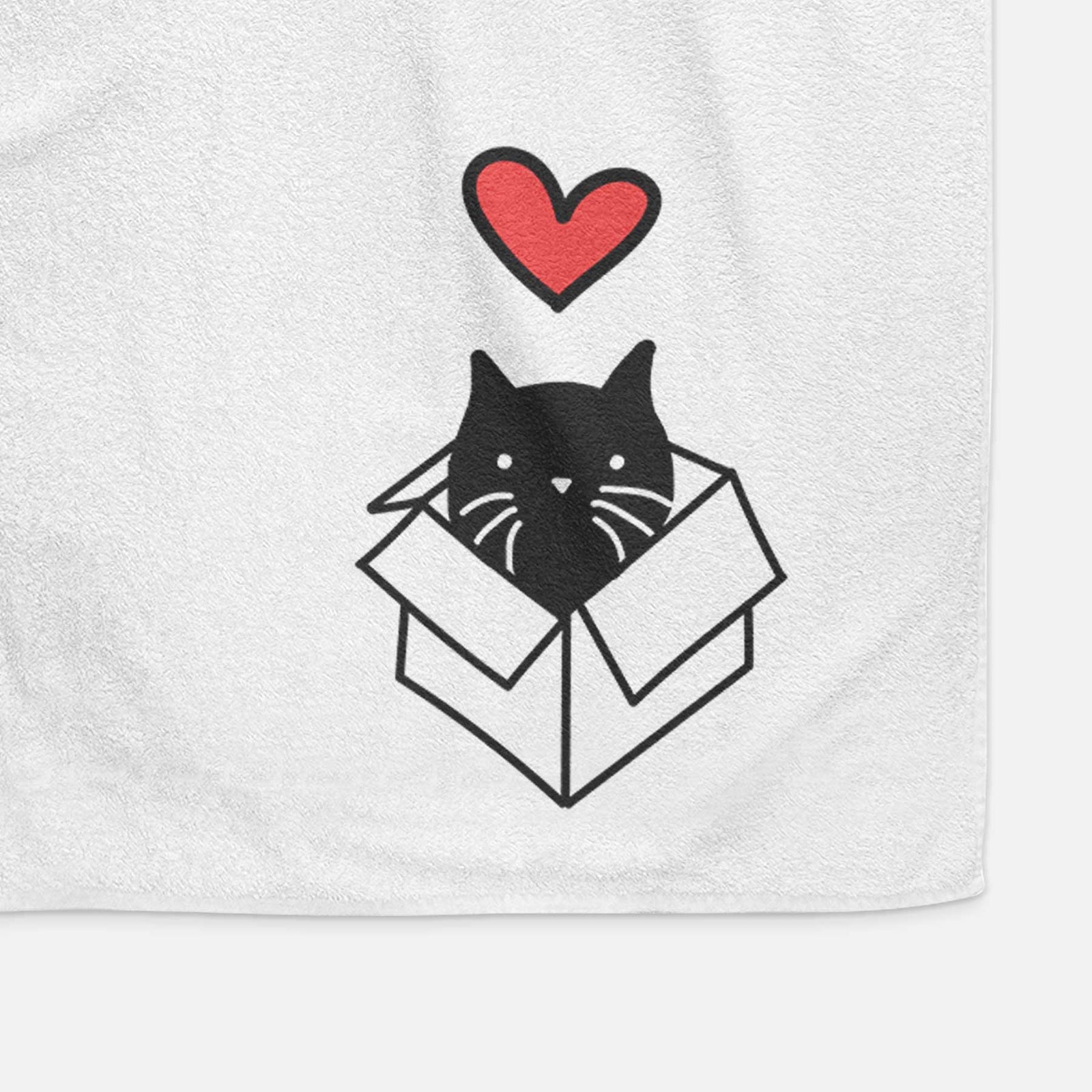 Minimalist line drawing of Doc the Black Cat in a Box with a red heart on a decorative hand towel