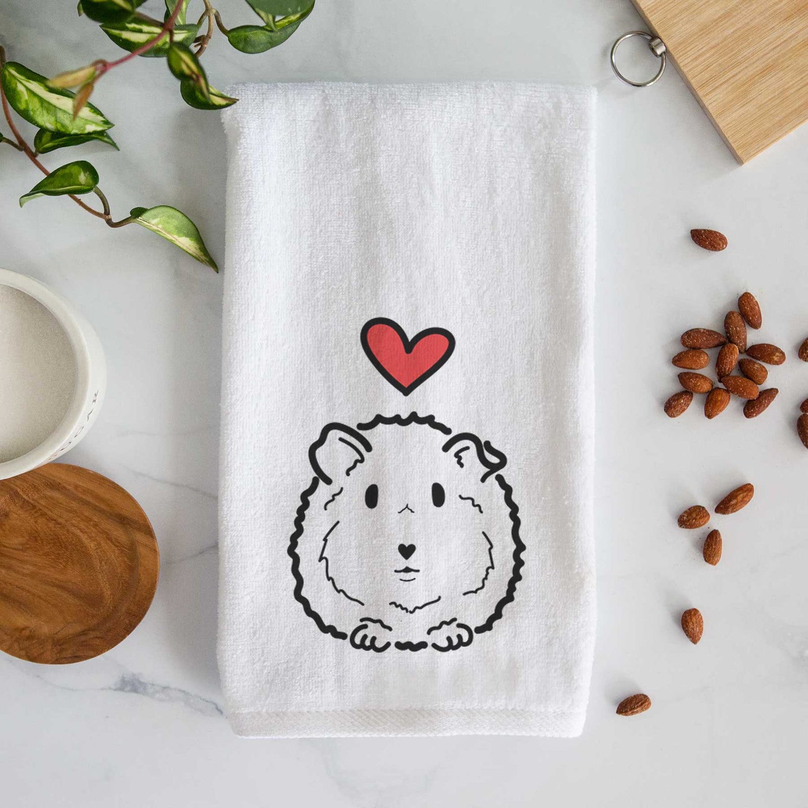Minimalist line drawing of Duke the Guinea Pig with a red heart on a decorative hand towel