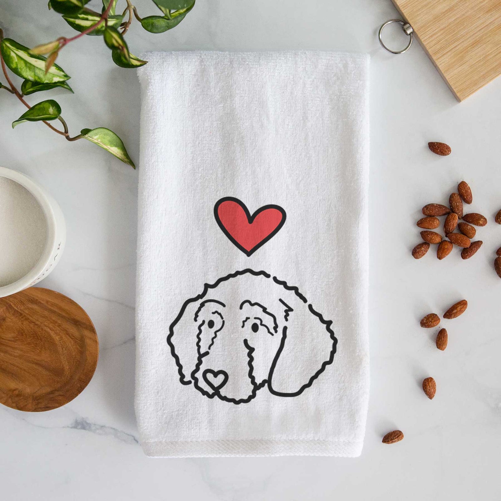 Minimalist line drawing of Hanna the Goldendoodle with a red heart on a decorative hand towel