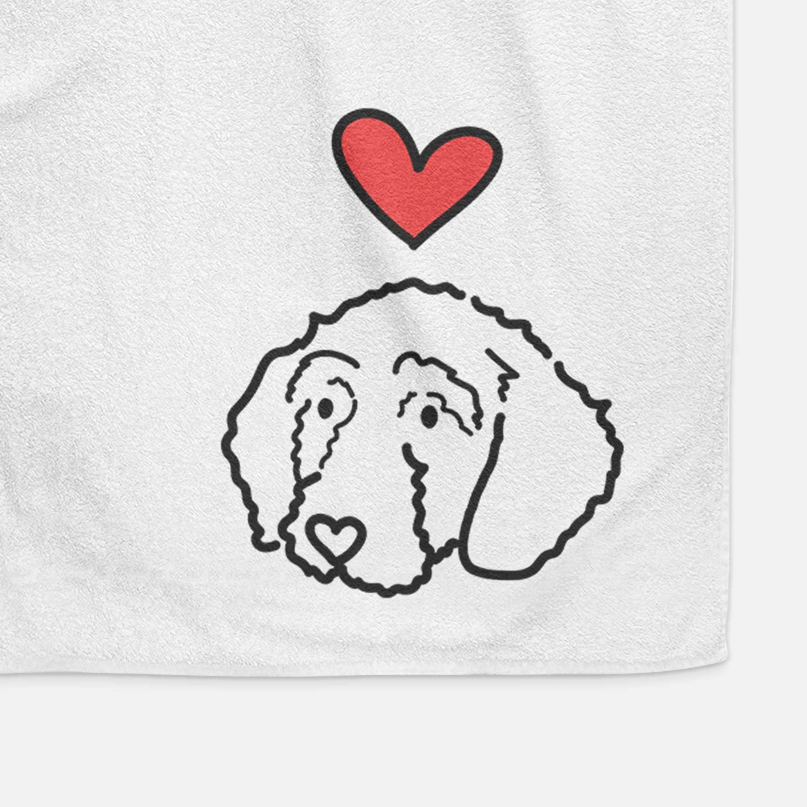 Minimalist line drawing of Hanna the Goldendoodle with a red heart on a decorative hand towel