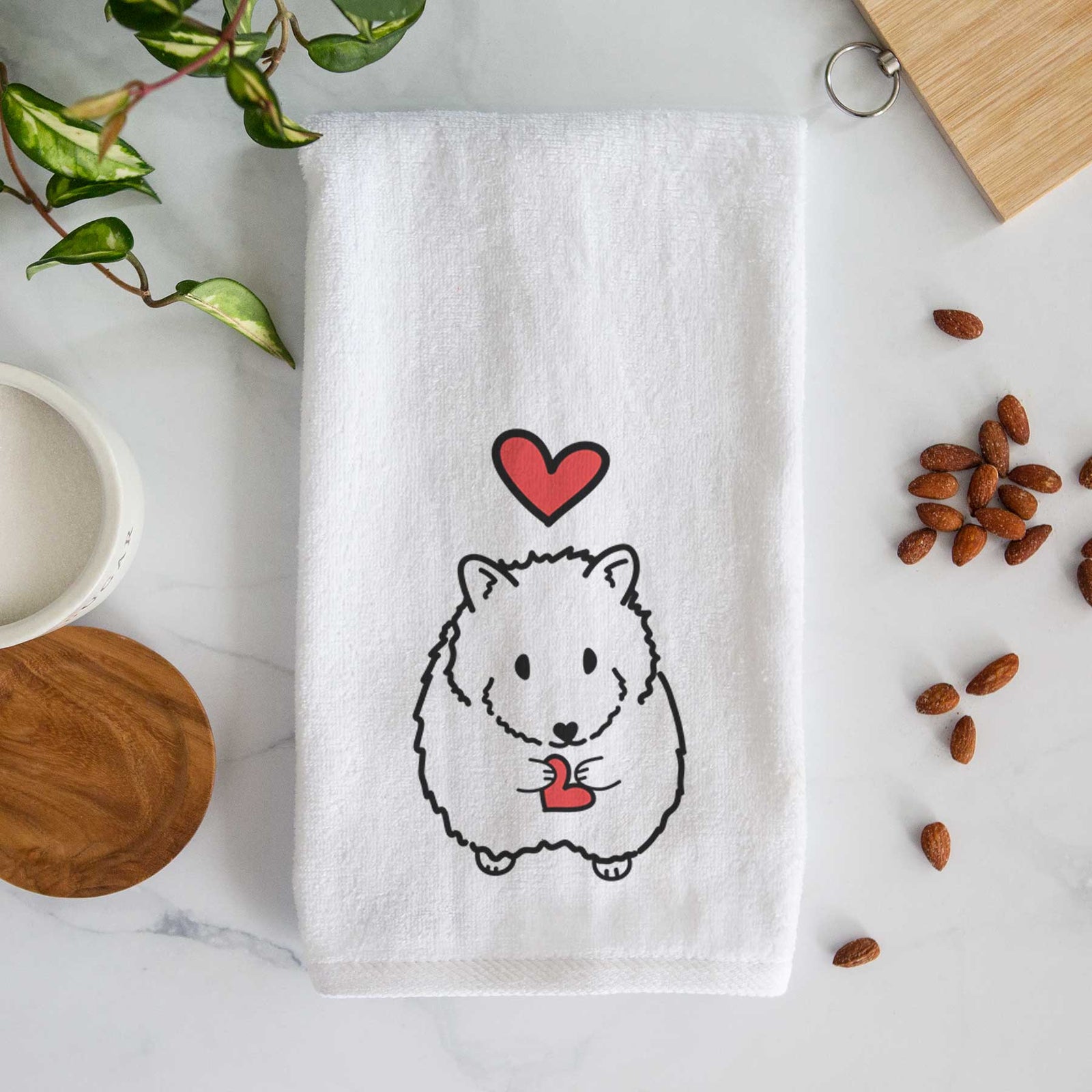 Minimalist line drawing of Hilga the Hamster with a red heart on a decorative hand towel