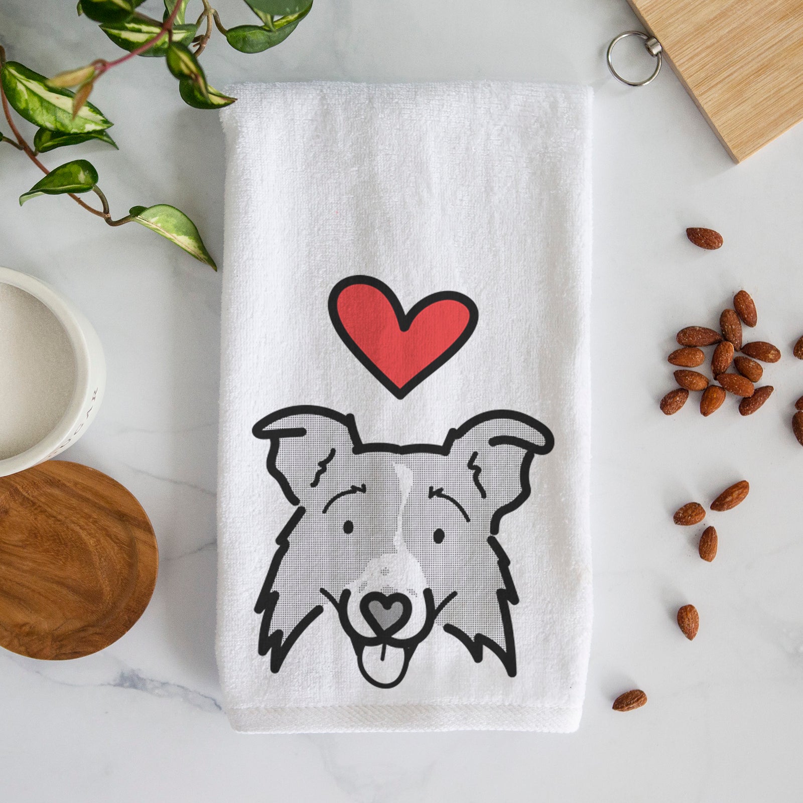 Minimalist line drawing of Jam the Border Collie 2.0 with a red heart on a decorative hand towel
