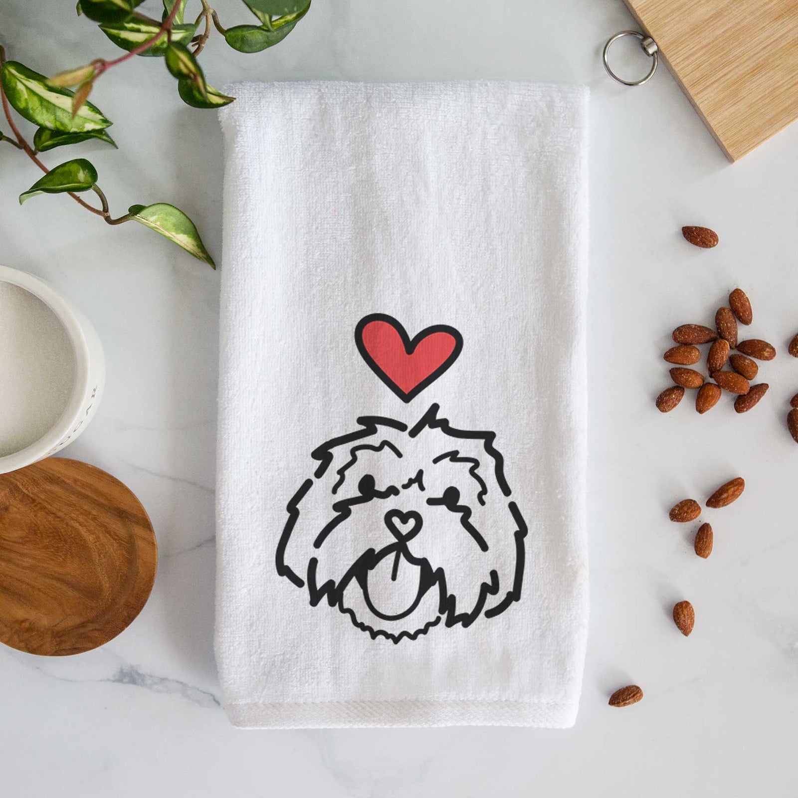 Minimalist line drawing of Keia the Lhasa Apso with a red heart on a decorative hand towel