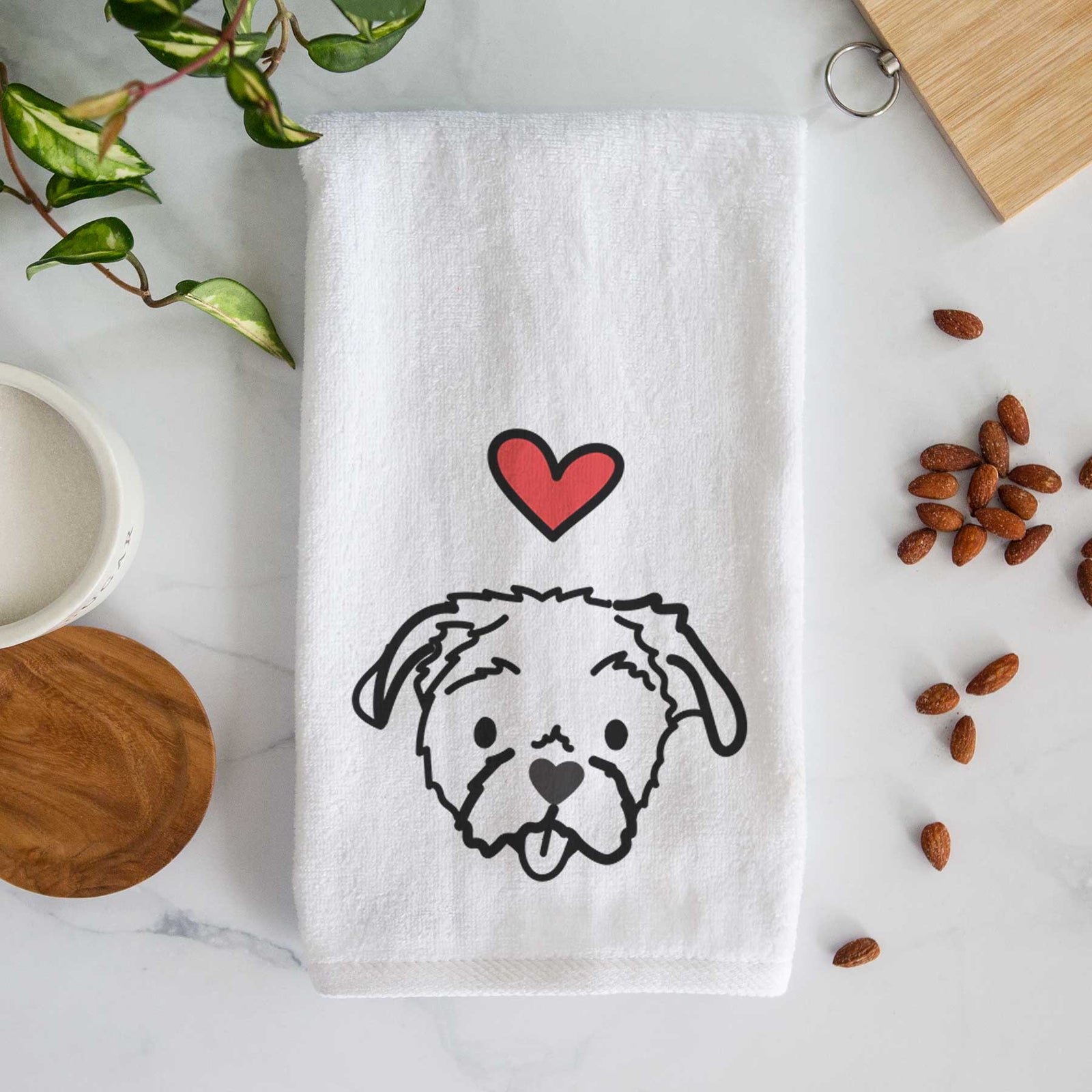 Minimalist line drawing of Koko the Shih Tzu with a red heart on a decorative hand towel