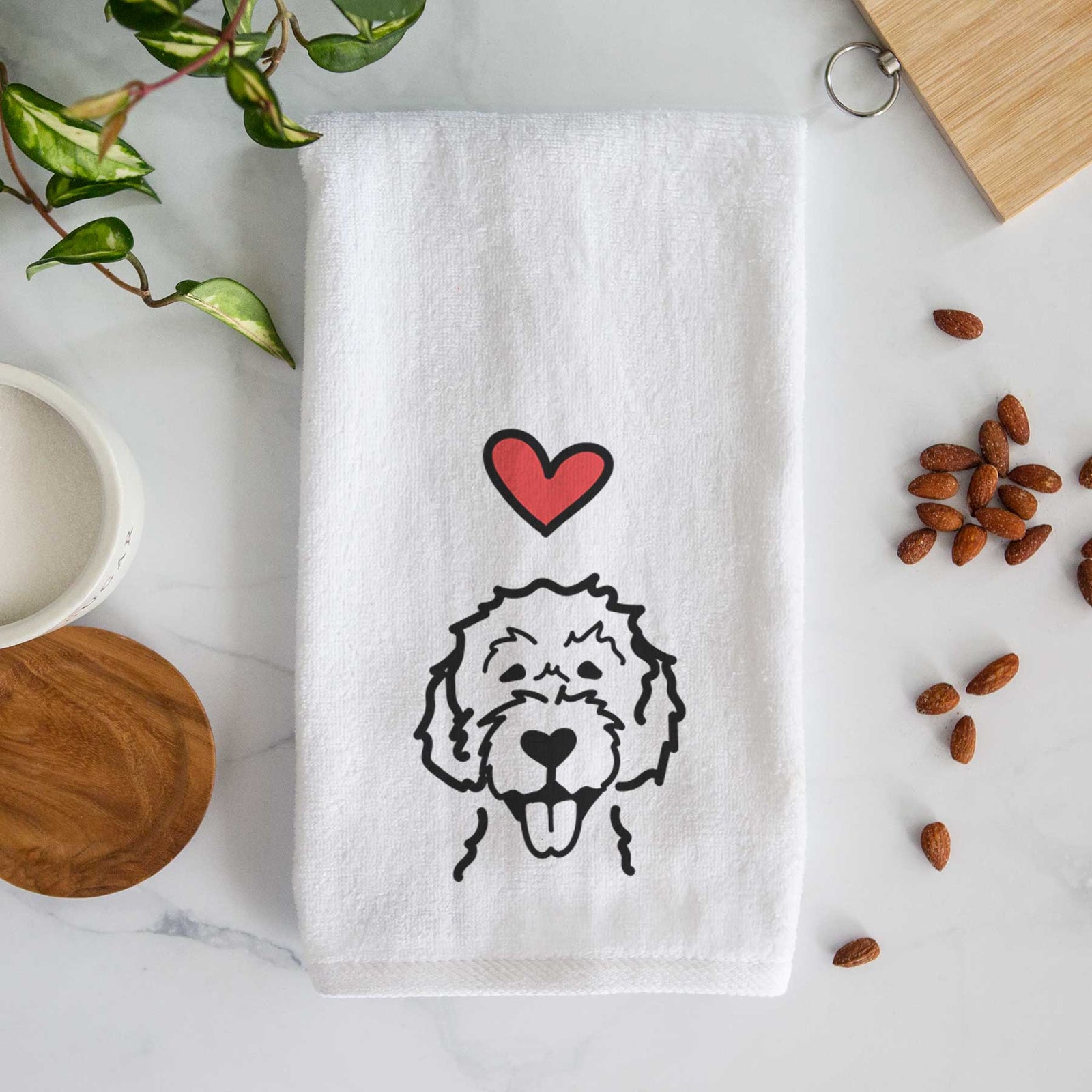 Minimalist line drawing of a Labradoodle with a red heart on a decorative hand towel