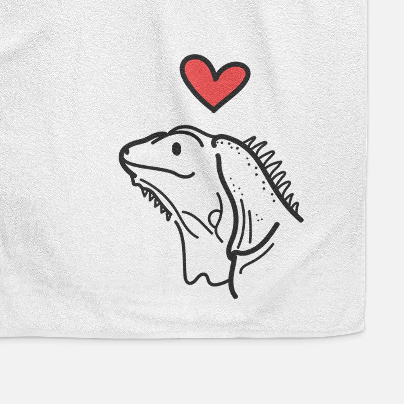 Minimalist line drawing of Louie the Iguana with a red heart on a decorative hand towel