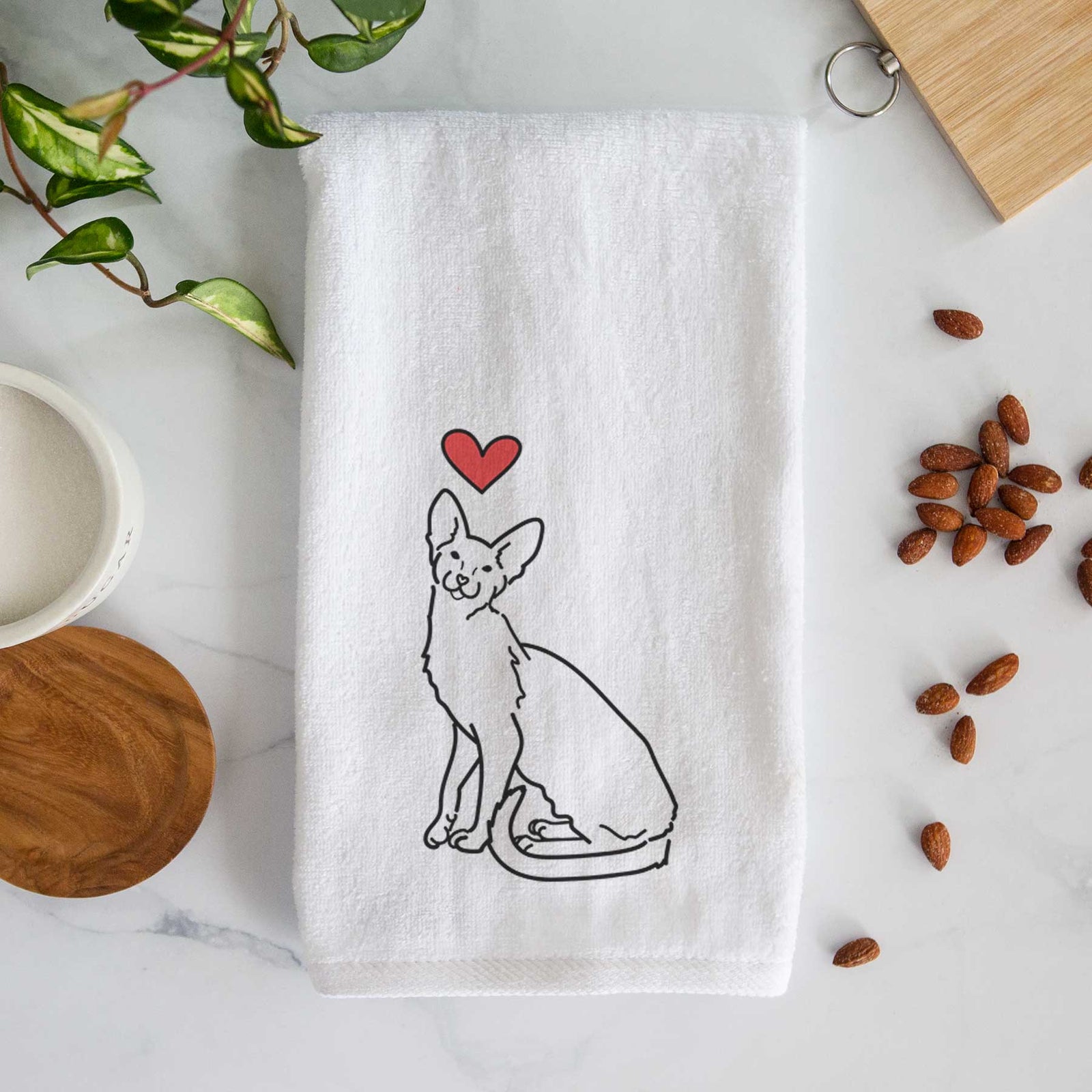 Minimalist line drawing of Lyra the Oriental Shorthair Cat with a red heart on a decorative hand towel