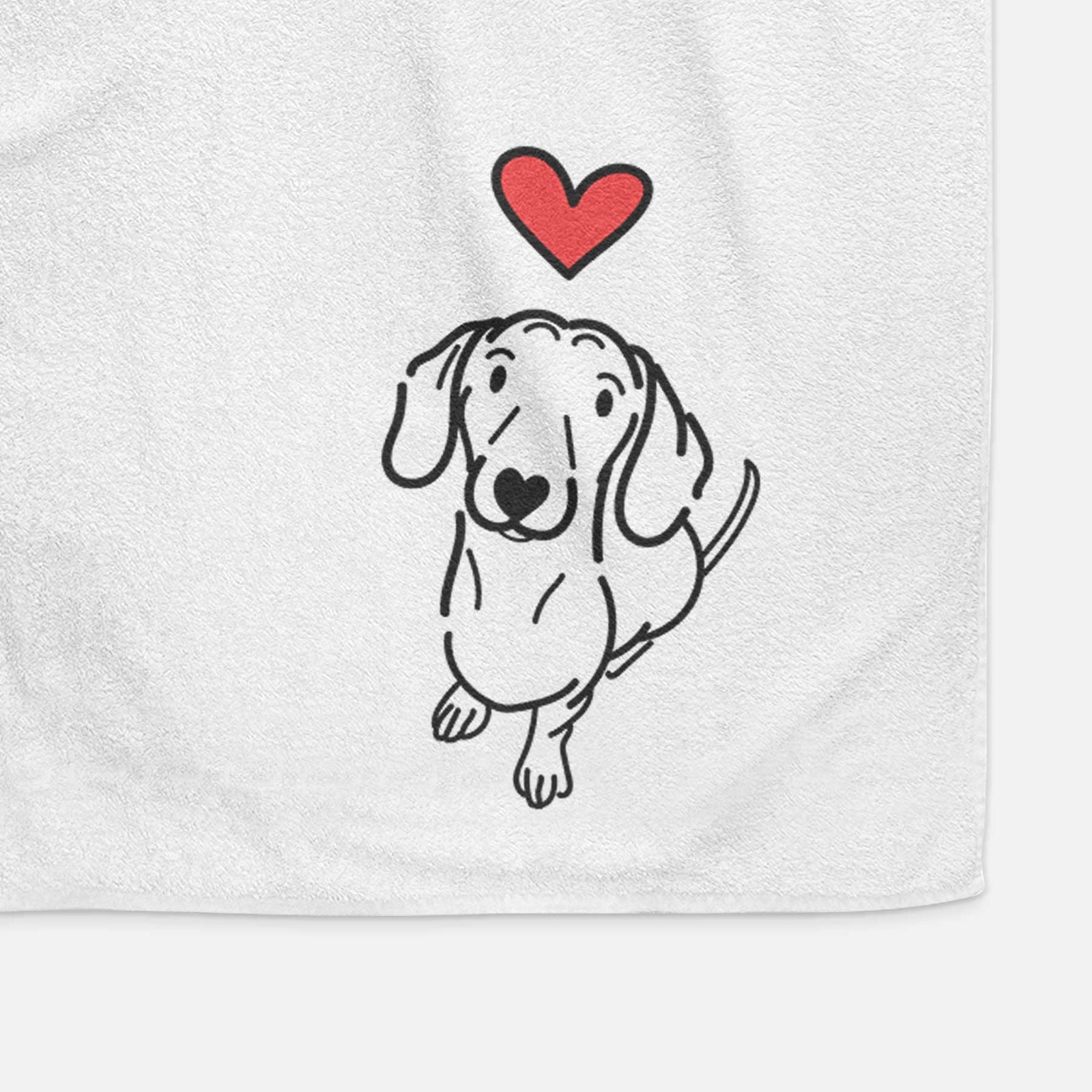 Minimalist line drawing of Moxie the Dachshund with a red heart on a decorative hand towel