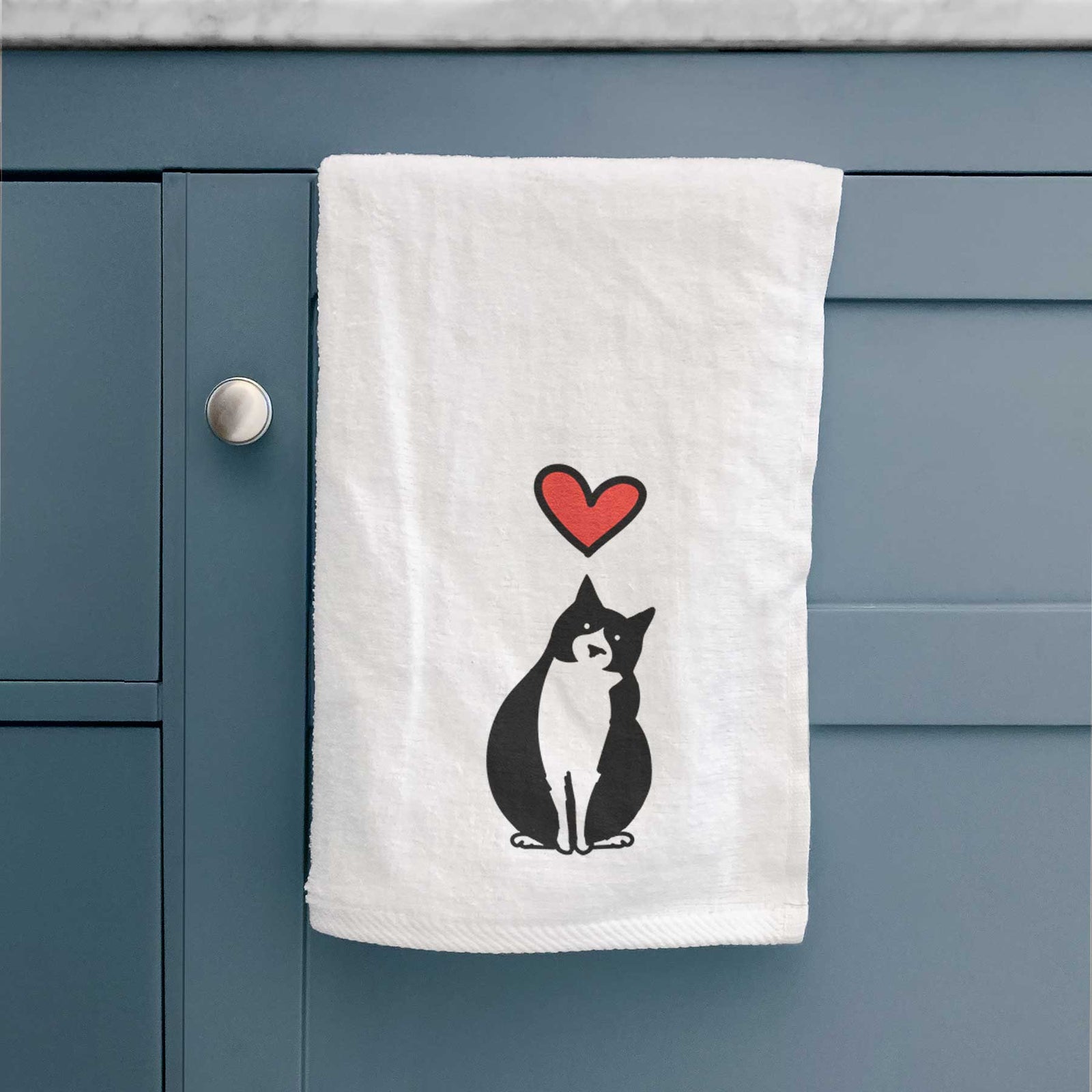 Minimalist line drawing of Oliver the Tuxedo Cat with a red heart on a decorative hand towel