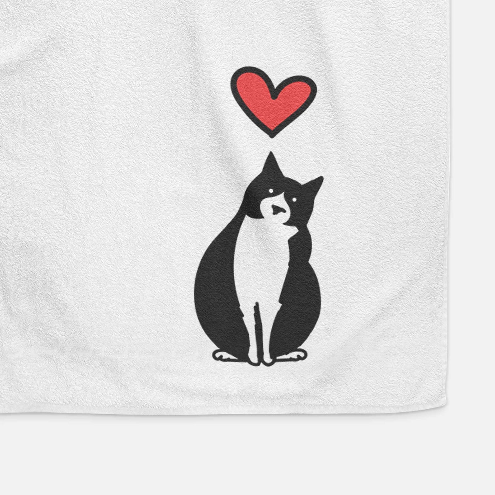 Minimalist line drawing of Oliver the Tuxedo Cat with a red heart on a decorative hand towel