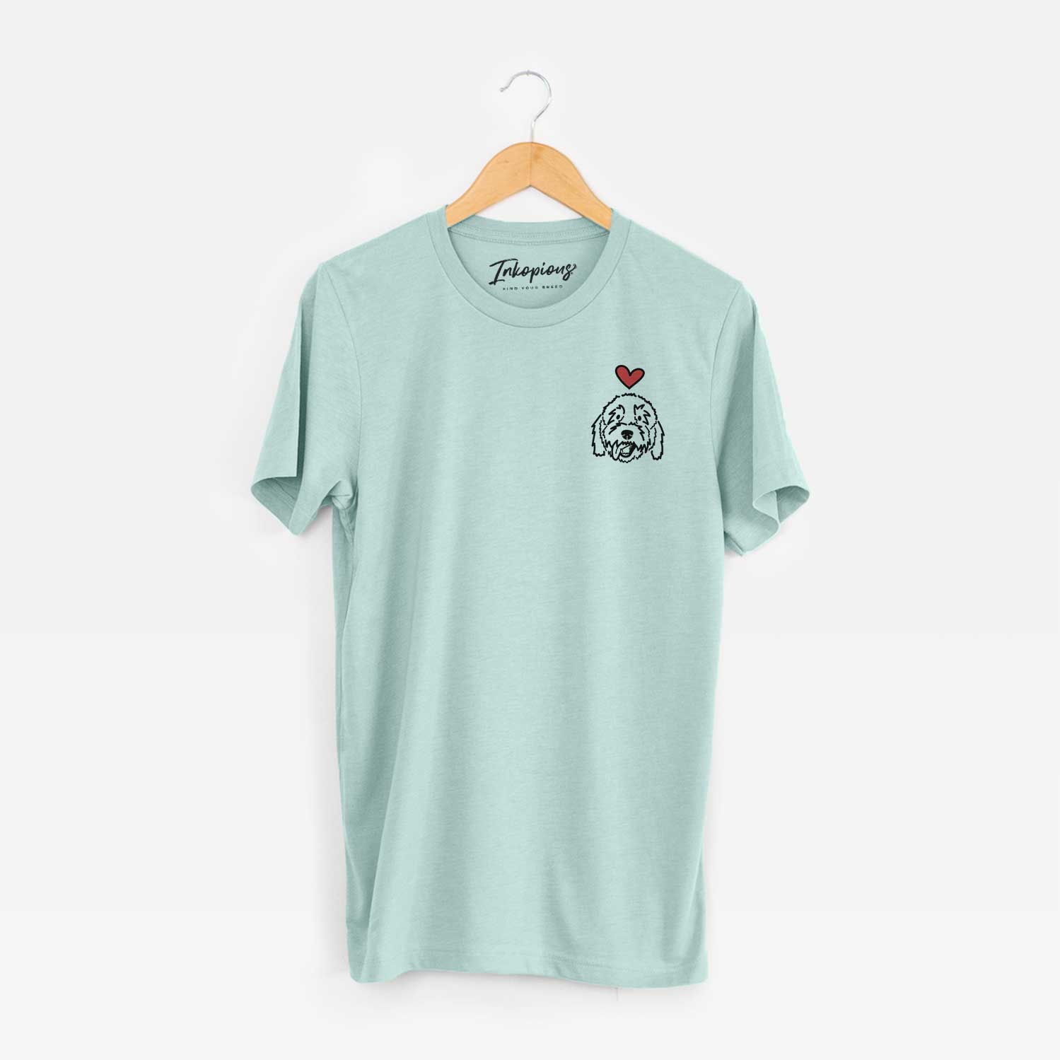 Small chest-pocket minimalist line drawing of Barry the Goldendoodle with a red heart on a Heather Sage Unisex crewneck