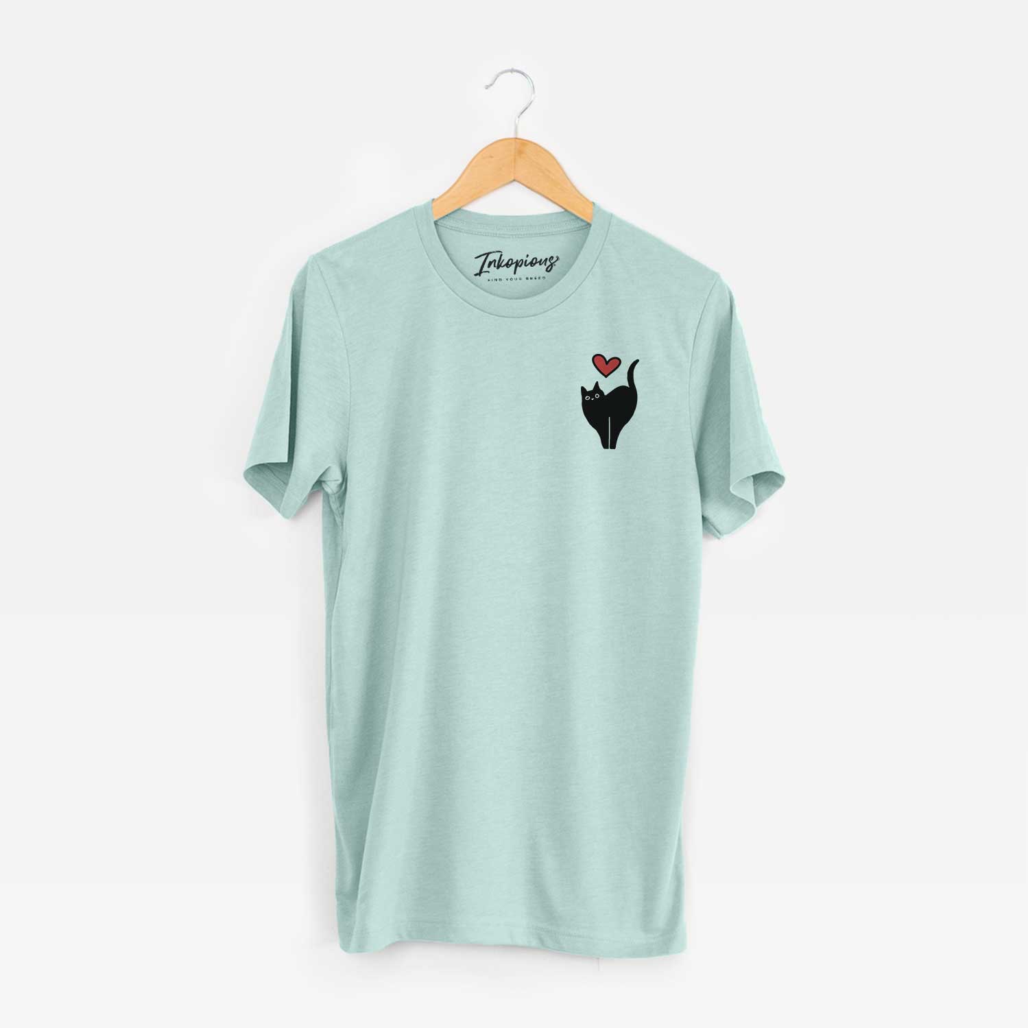 Small chest-pocket minimalist line drawing of Bella the Black Cat with a red heart on a Heather Sage Unisex crewneck