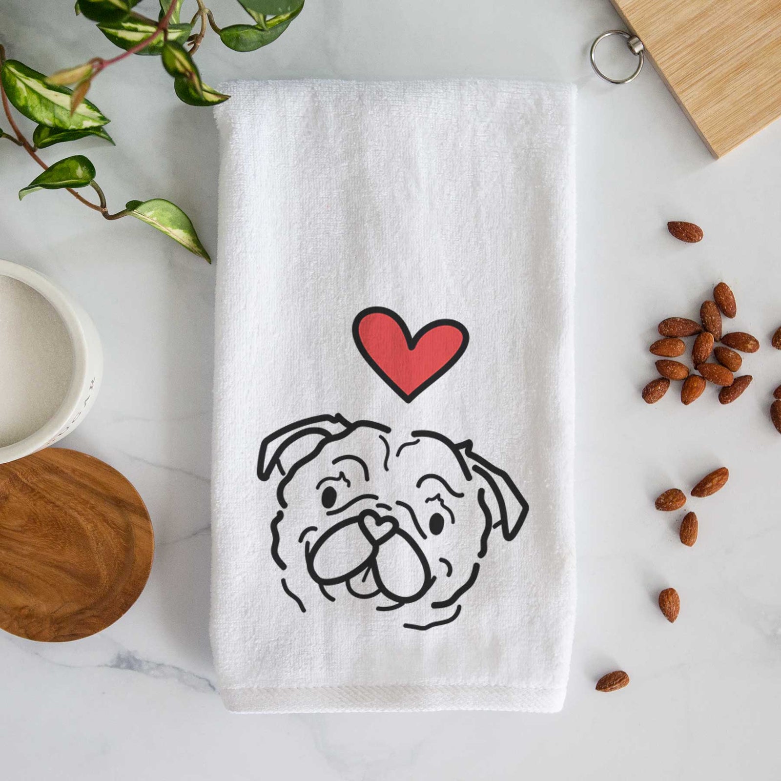 Minimalist line drawing of Pip the Pug with a red heart on a decorative hand towel