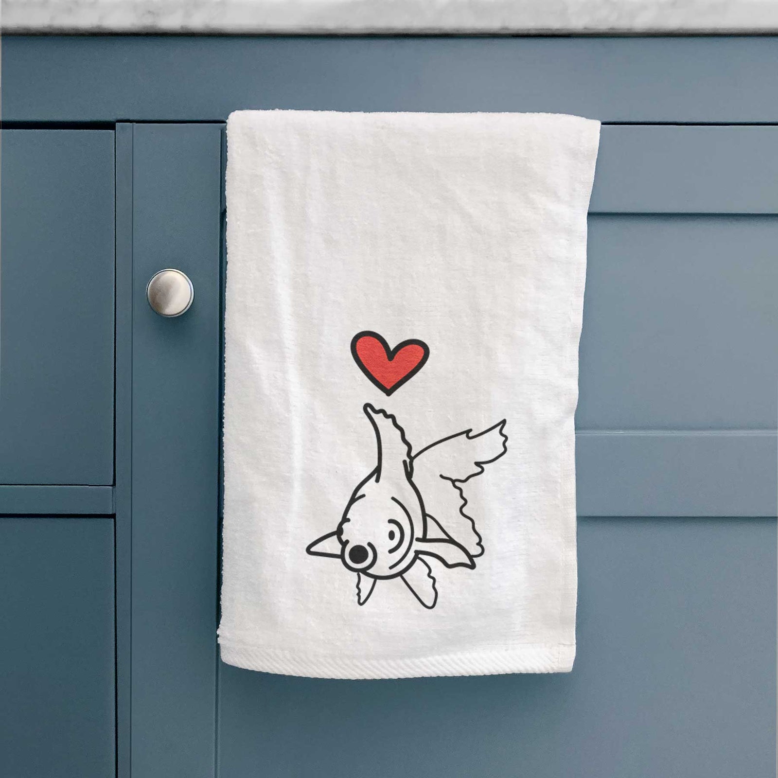 Minimalist line drawing of Ruby the Goldfish with a red heart on a decorative hand towel