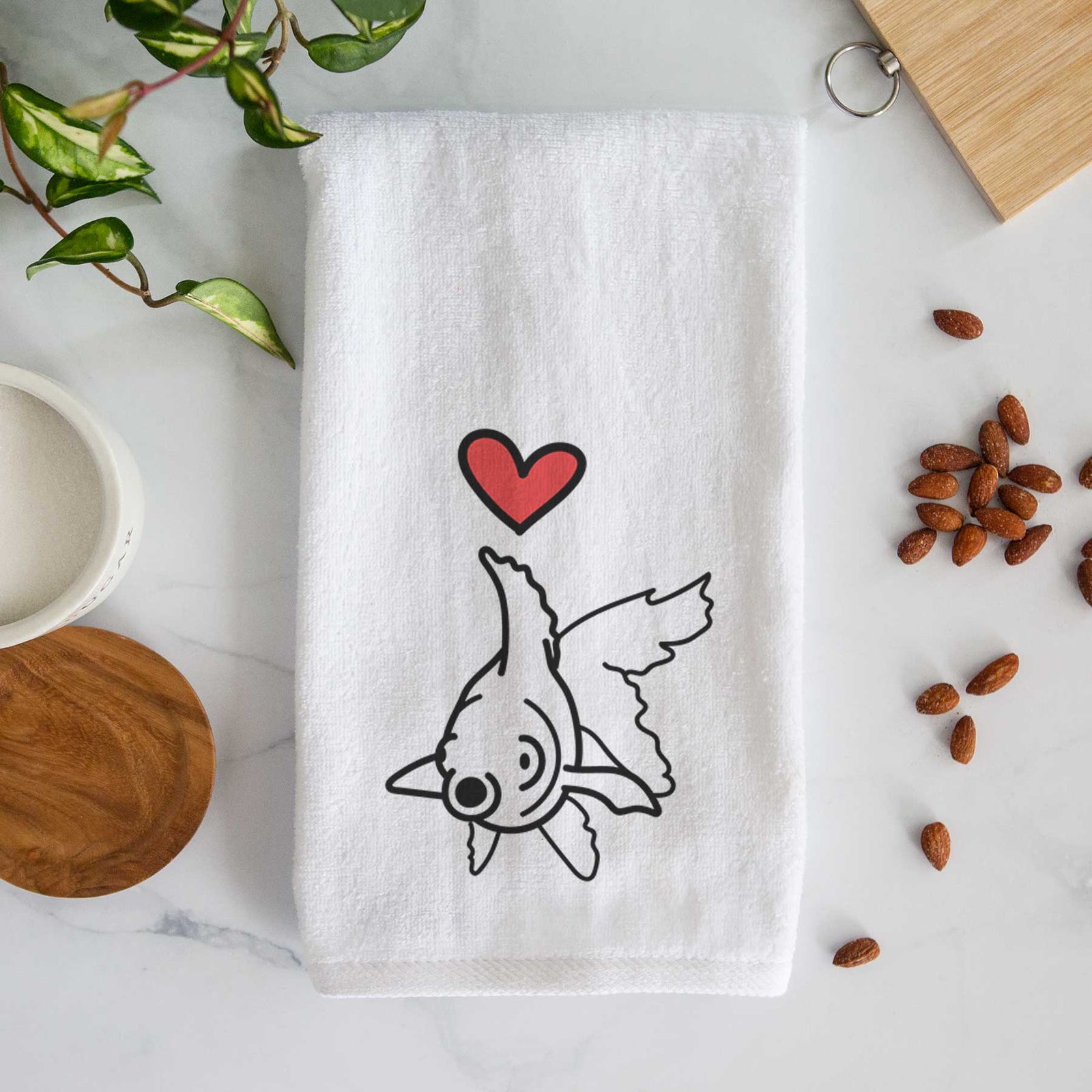 Minimalist line drawing of Ruby the Goldfish with a red heart on a decorative hand towel