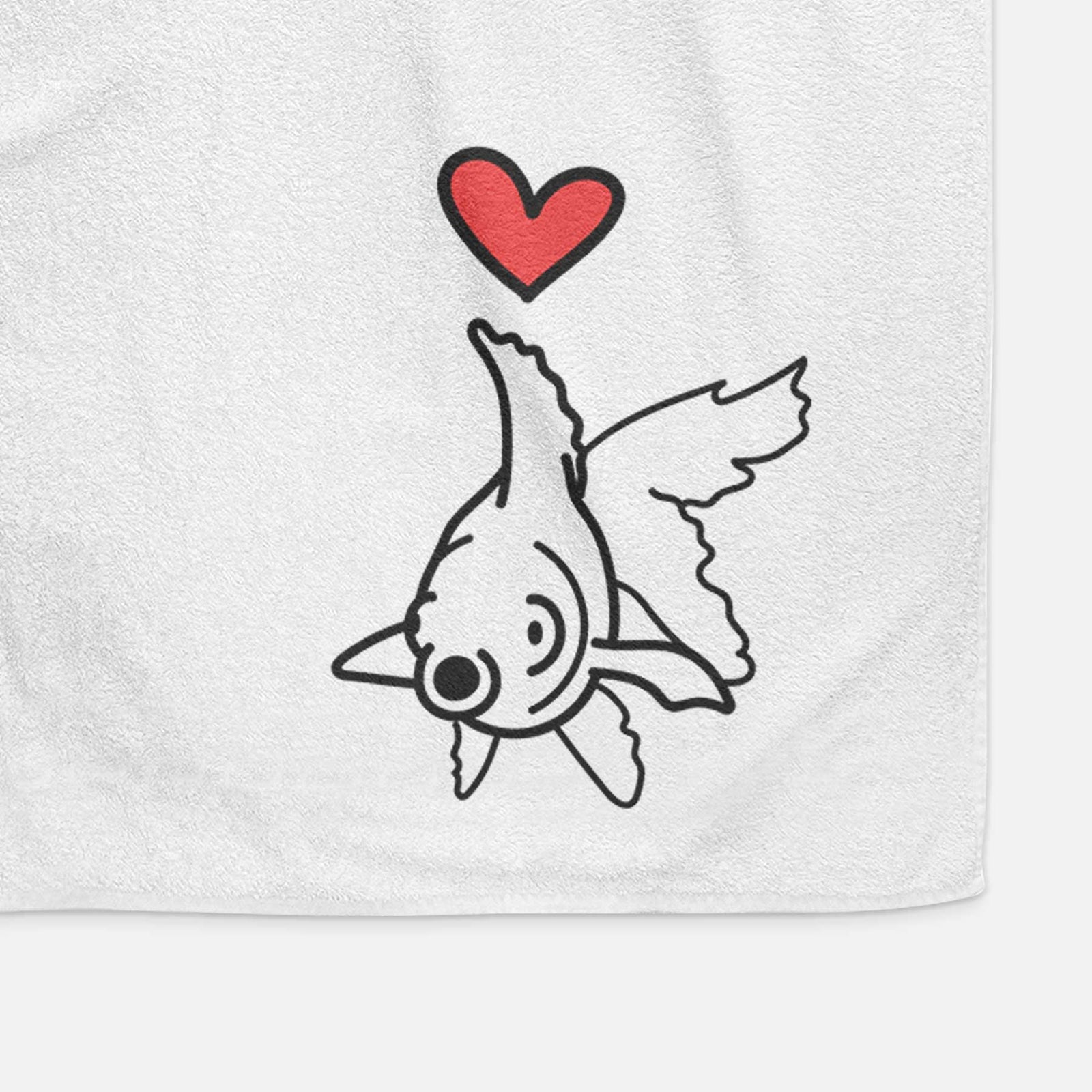 Minimalist line drawing of Ruby the Goldfish with a red heart on a decorative hand towel