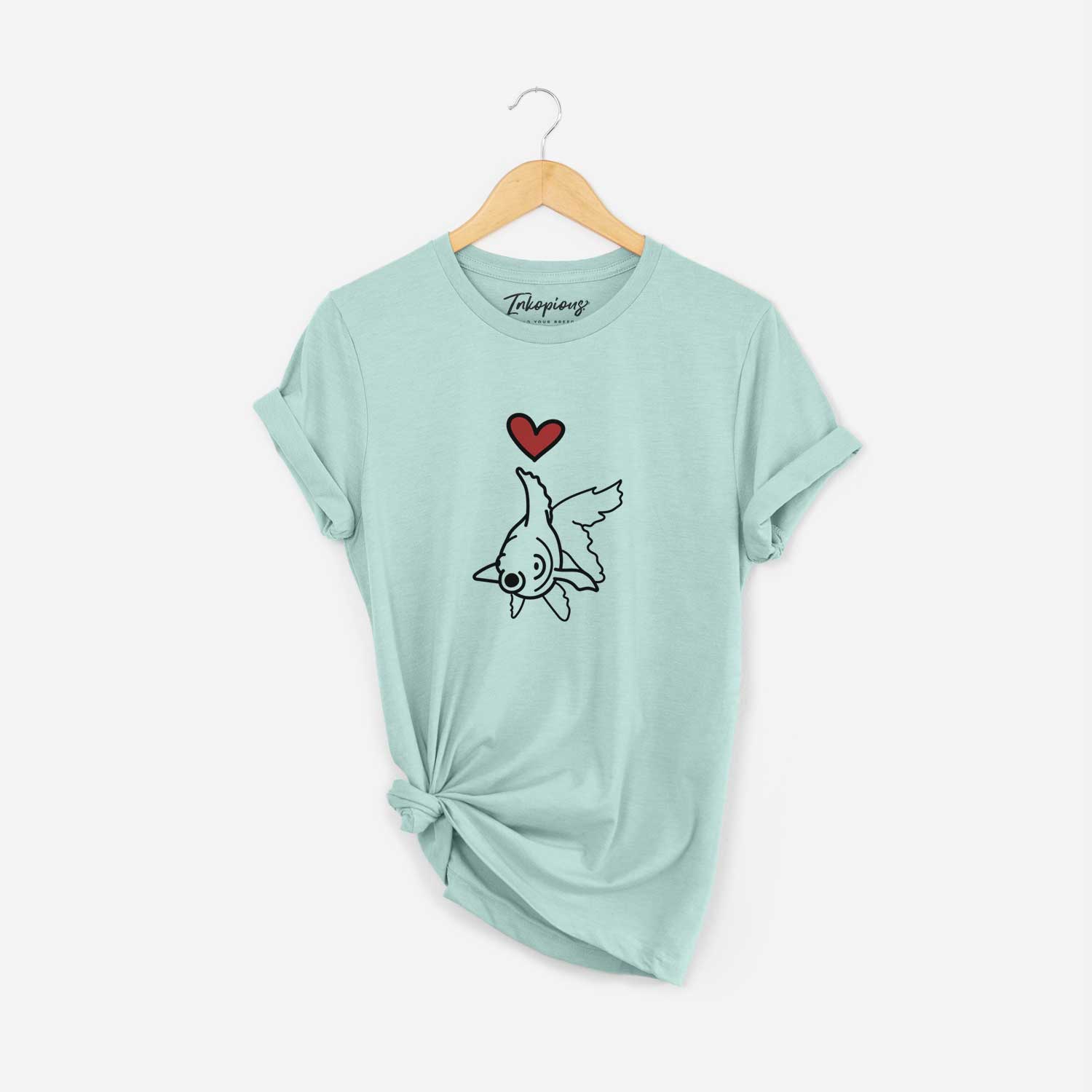 Minimalist line drawing of Ruby the Goldfish with a red heart on a Heather Sage Unisex crewneck