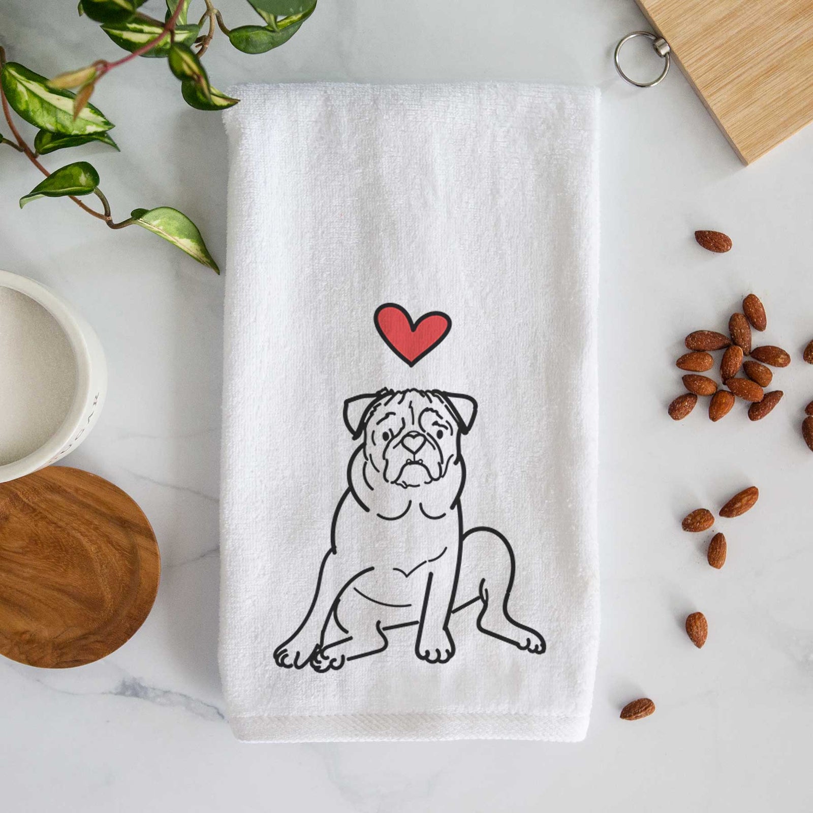 Minimalist line drawing of Rudy the Pug with a red heart on a decorative hand towel