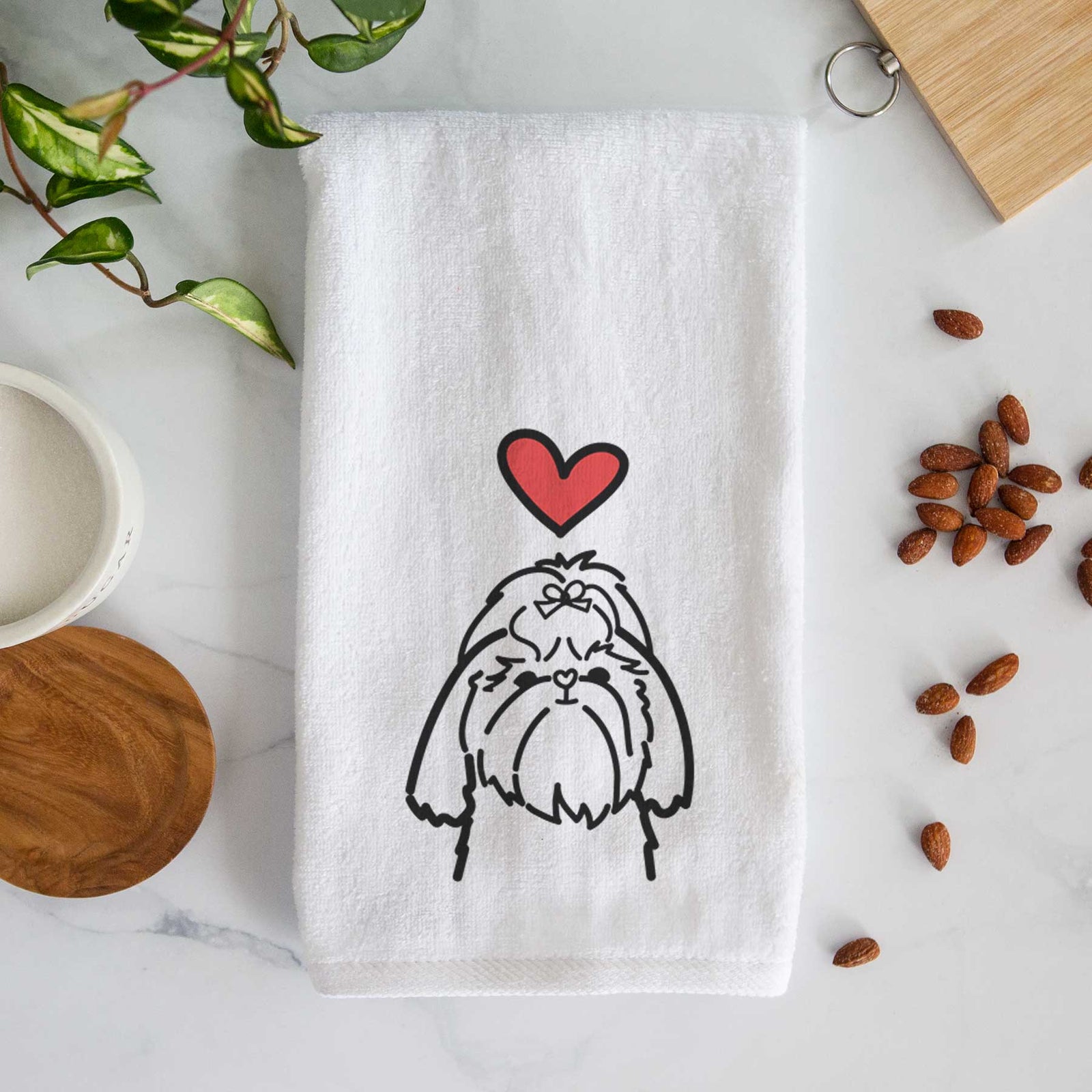 Minimalist line drawing of a Shih Tzu with a red heart on a decorative hand towel