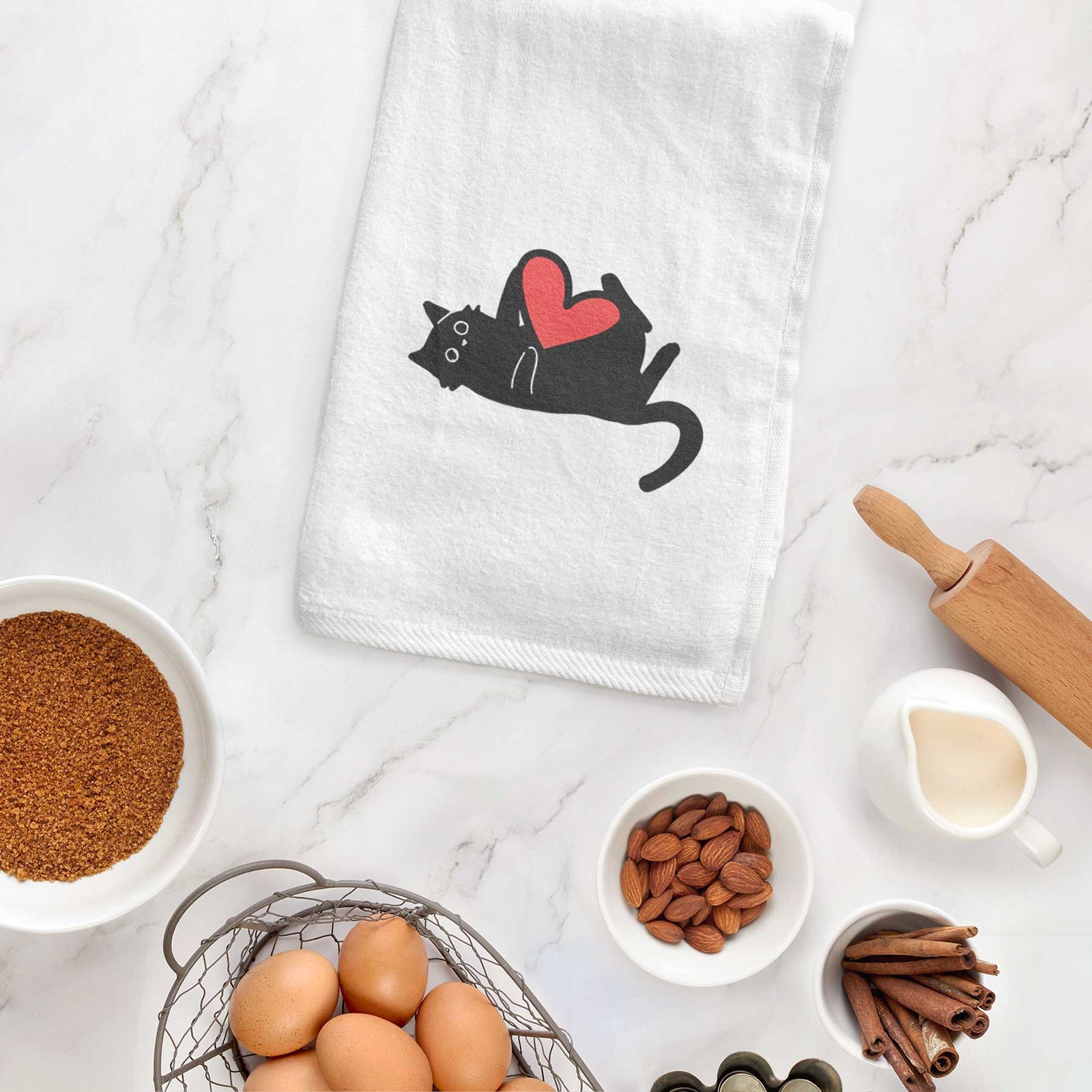 Minimalist line drawing of Smash the Black Cat with a red heart on a decorative hand towel