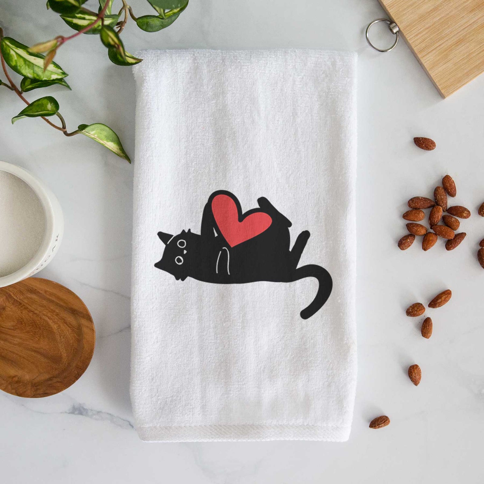 Minimalist line drawing of Smash the Black Cat with a red heart on a decorative hand towel