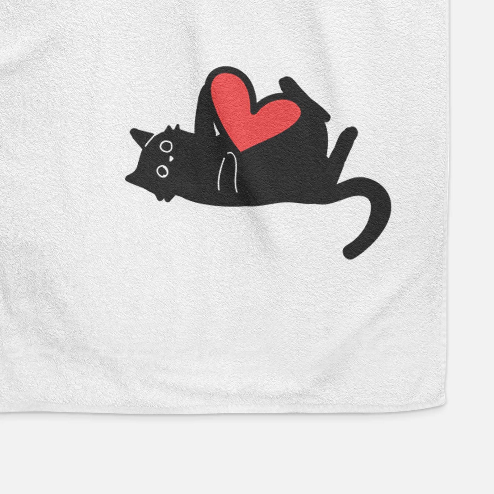 Minimalist line drawing of Smash the Black Cat with a red heart on a decorative hand towel