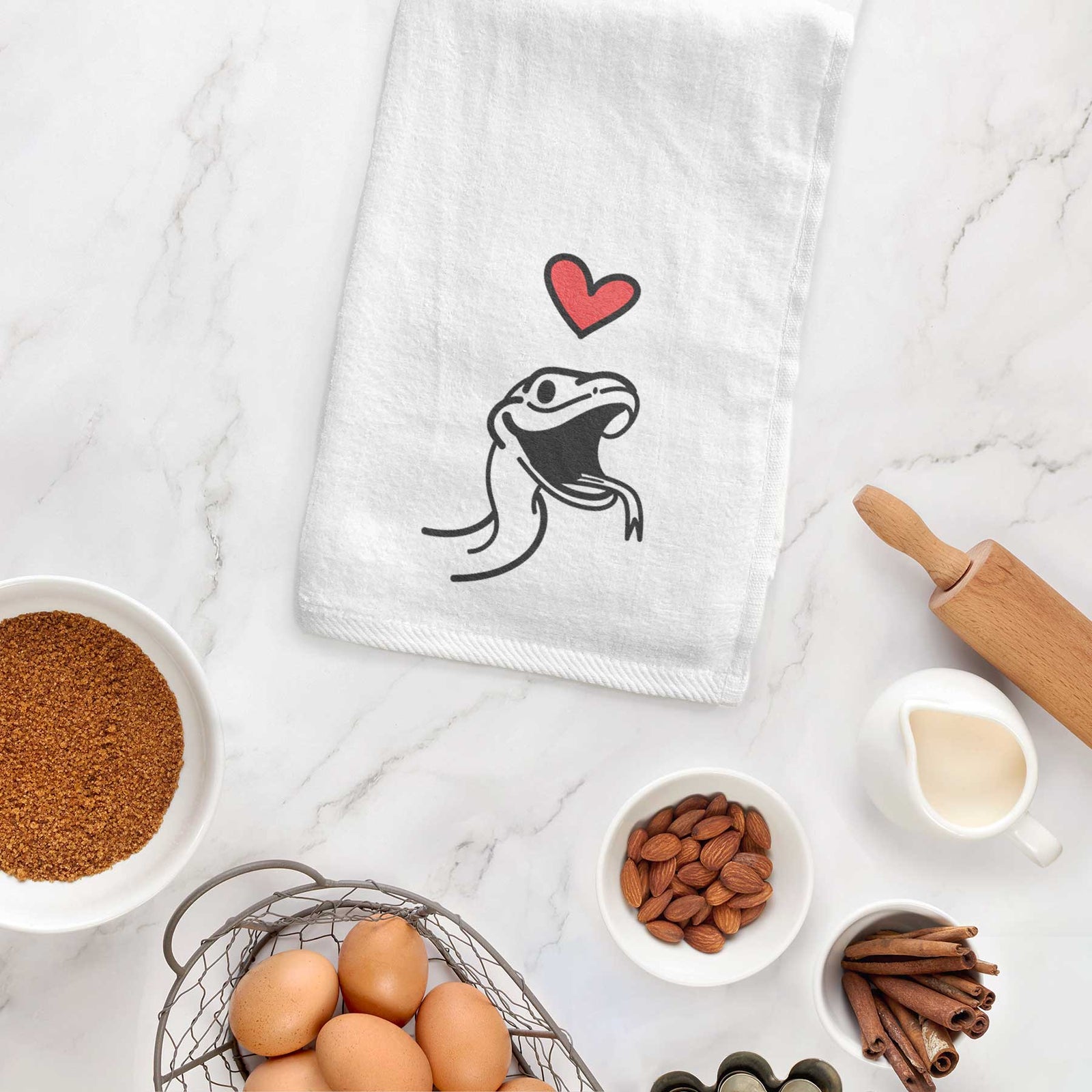 Minimalist line drawing of Spike the Snake with a red heart on a decorative hand towel