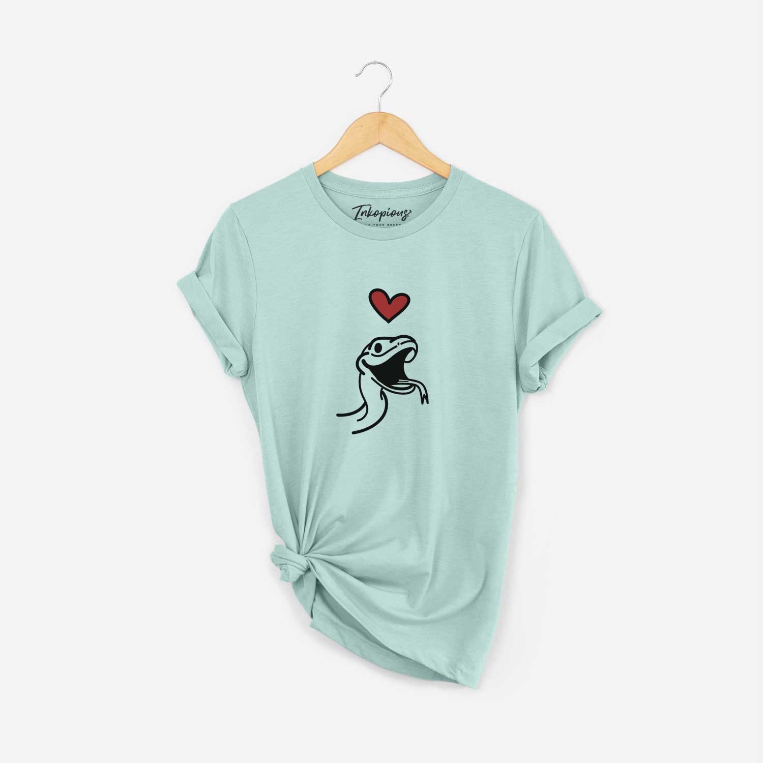 Minimalist line drawing of Spike the Snake with a red heart on a Heather Sage Unisex crewneck