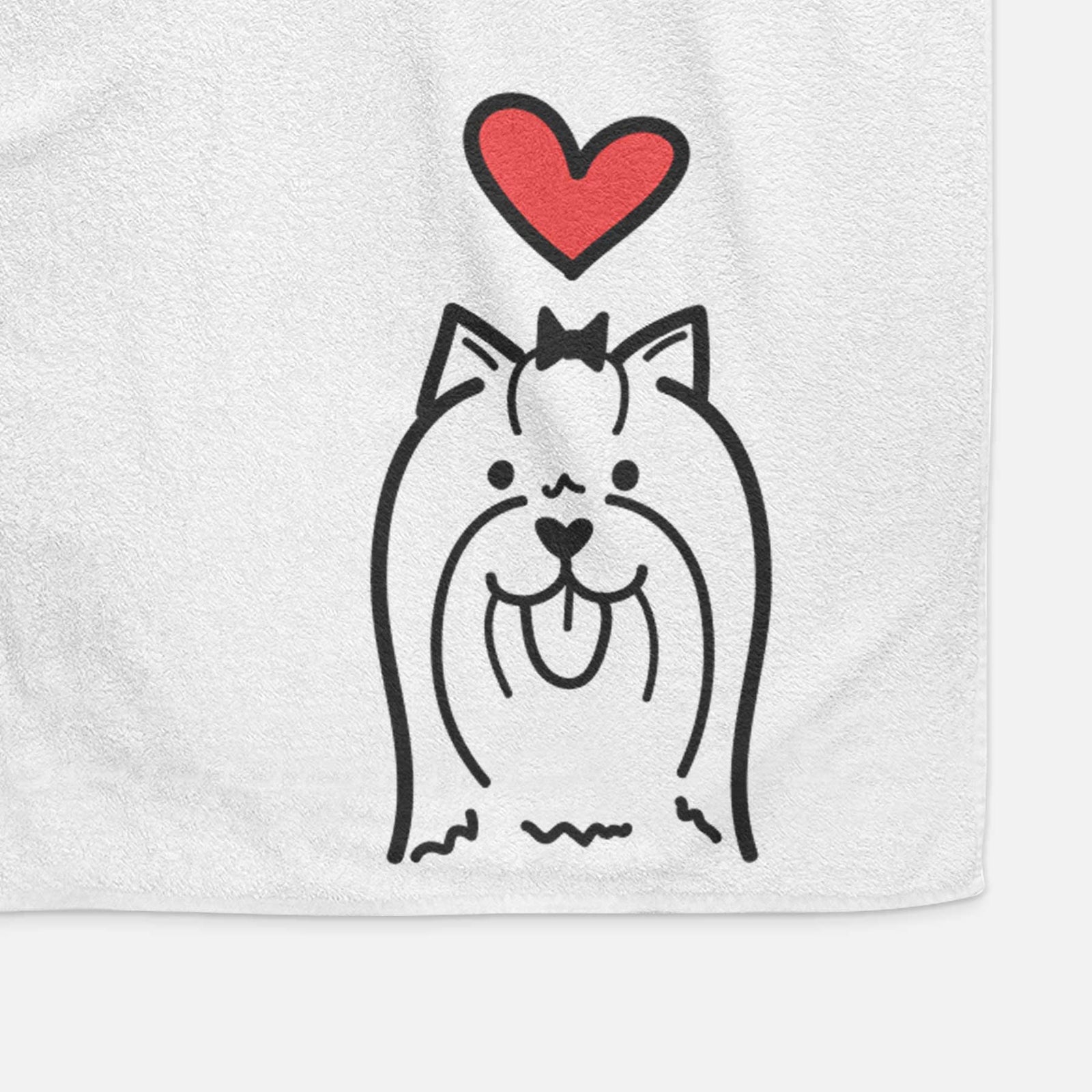 Minimalist line drawing of a Yorkshire Terrier with a red heart on a decorative hand towel