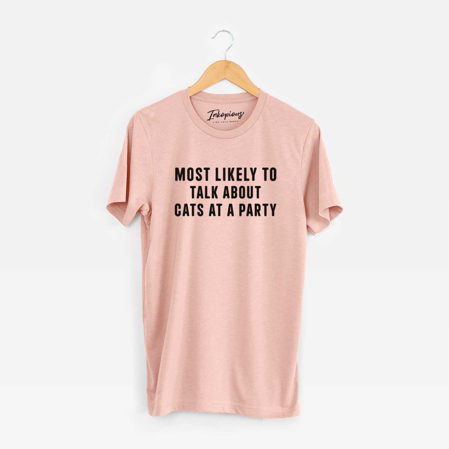 'Most Likely to Talk About Cats at a Party' design on a Peach Unisex crewneck