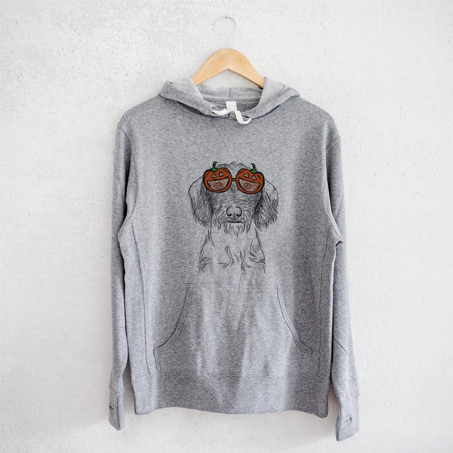 Hand-drawn sketch of Almond the Wirehaired Dachshund wearing pumpkin glasses on a Grey pumpkin collection, on a hanger