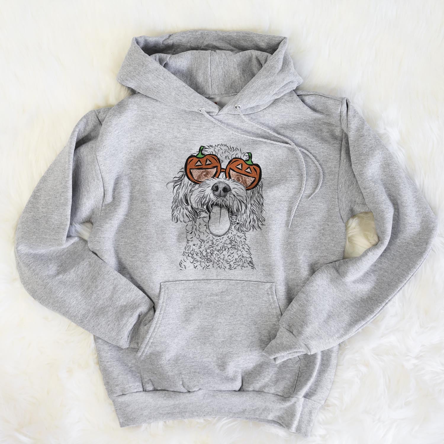Hand-drawn sketch of Barney the Cavachon wearing pumpkin glasses on a Grey pumpkin collection, flat lay