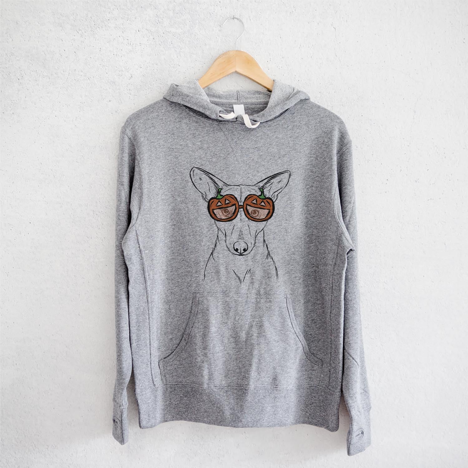 Hand-drawn sketch of Buff the Dorgi wearing pumpkin glasses on a Grey pumpkin collection, on a hanger