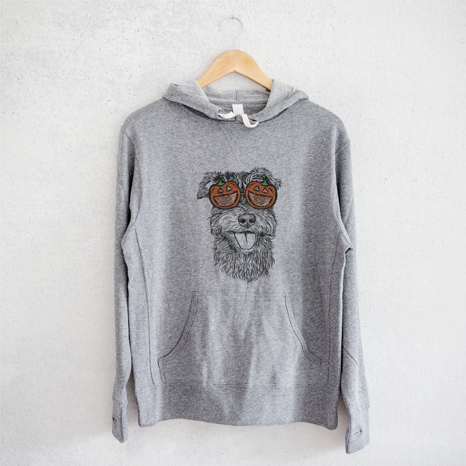Hand-drawn sketch of Buster the Schnoodle wearing pumpkin glasses on a Grey pumpkin collection, on a hanger