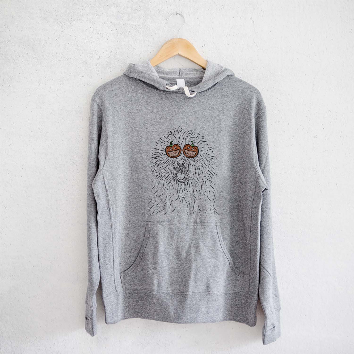 Hand-drawn sketch of Cozie the Old English Sheepdog wearing pumpkin glasses on a Grey pumpkin collection, on a hanger