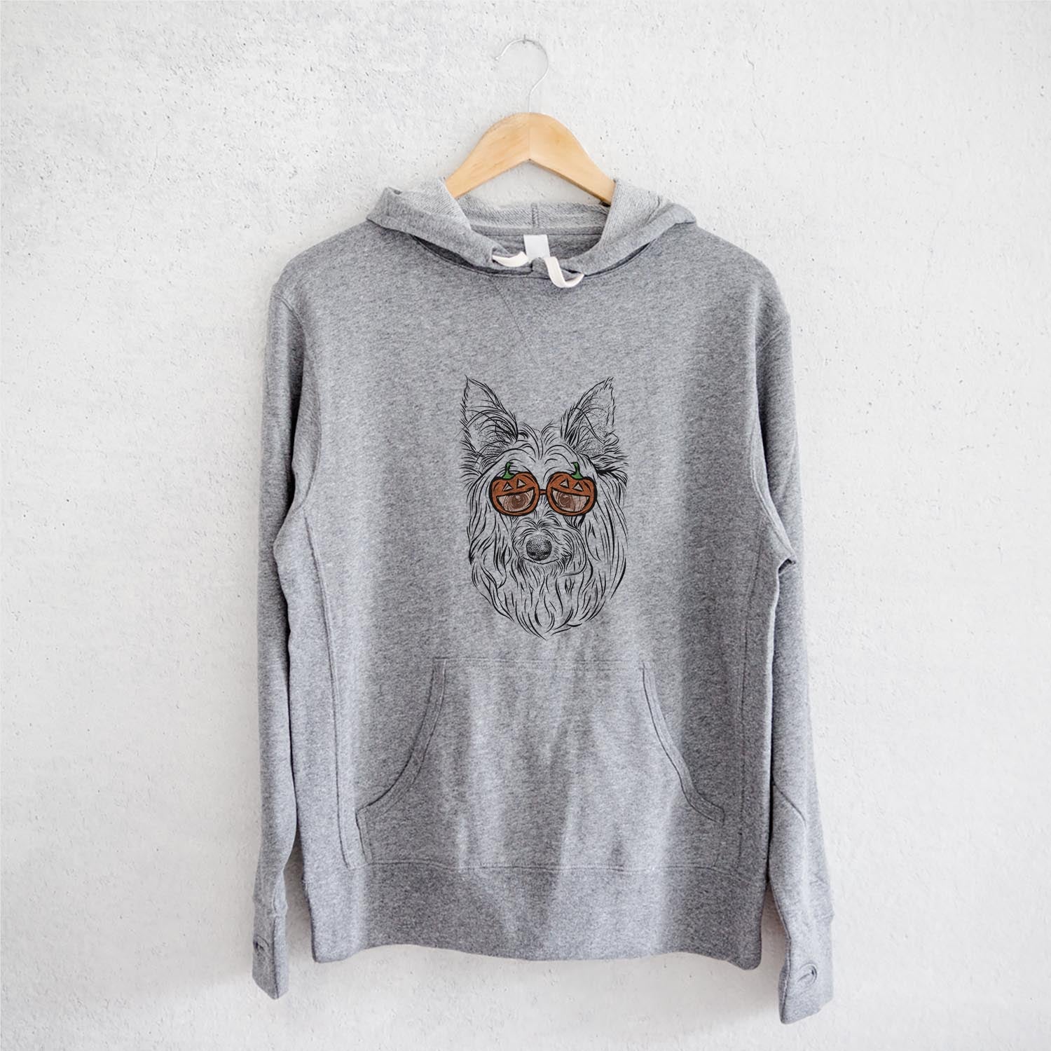Hand-drawn sketch of Daisy May the Silky Terrier wearing pumpkin glasses on a Grey pumpkin collection, on a hanger